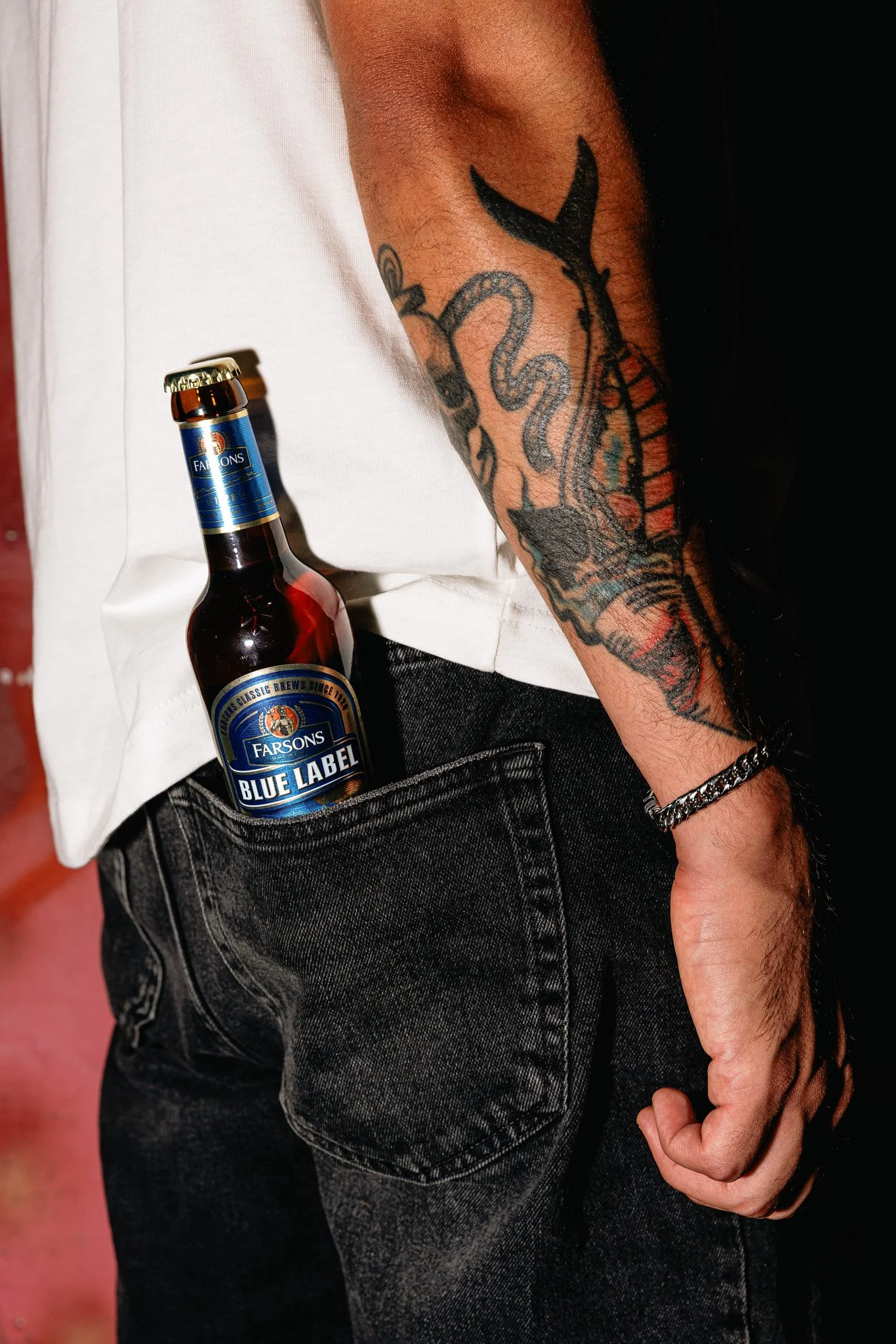 blue label classic brews bottle in back pocket of jeans