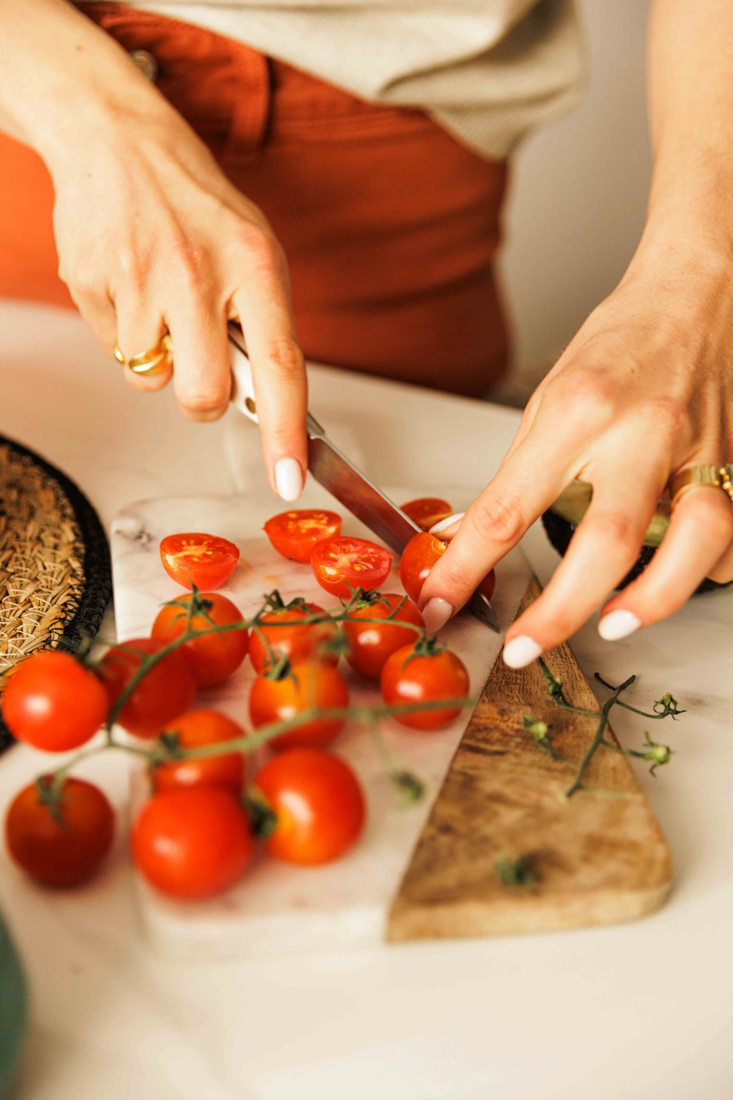 tomatoes being sliced, cutting board, nutritionist