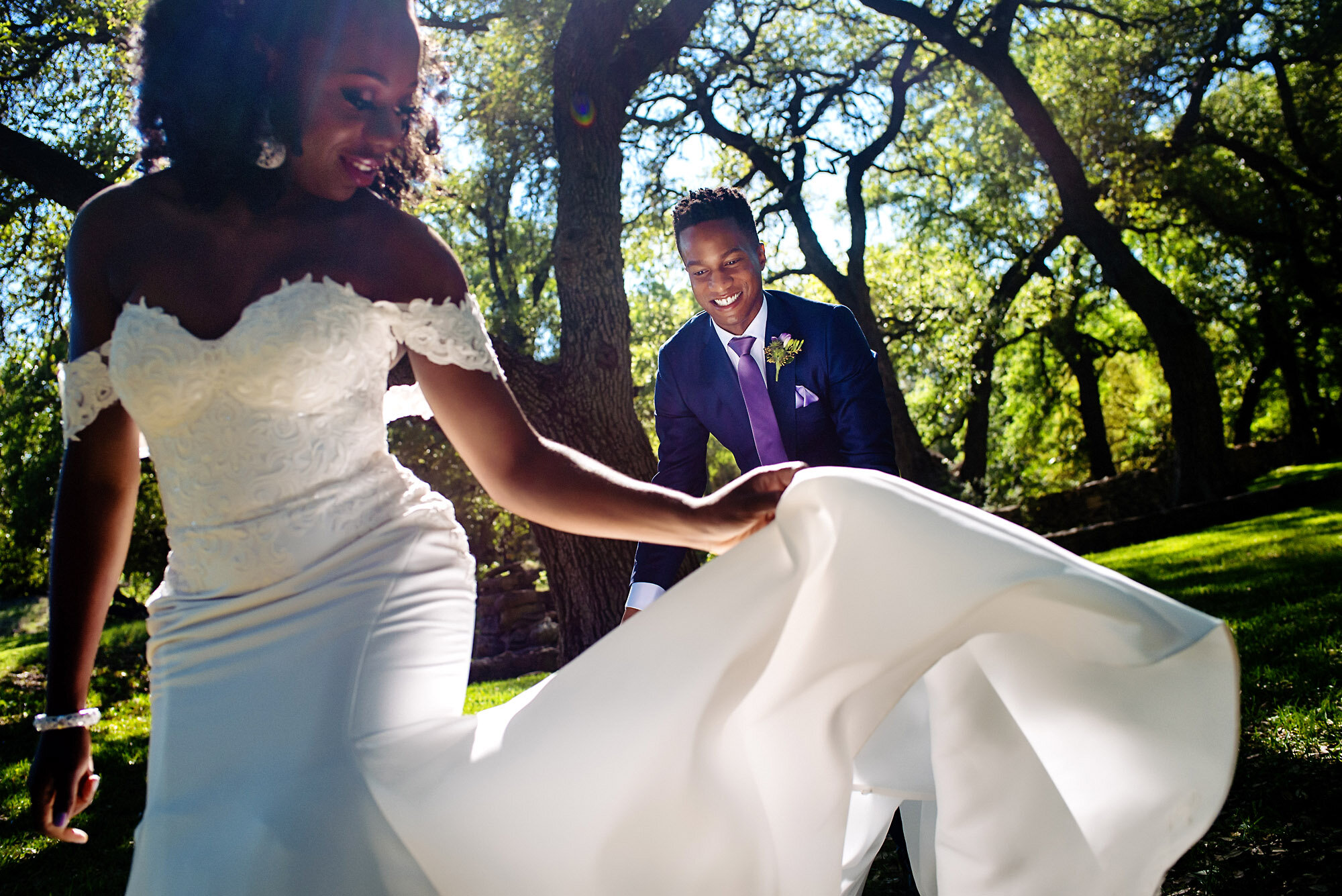 17-Austin-wedding-photographer-Jide-Alakija-groom helping bride spread her dress.jpg.JPG
