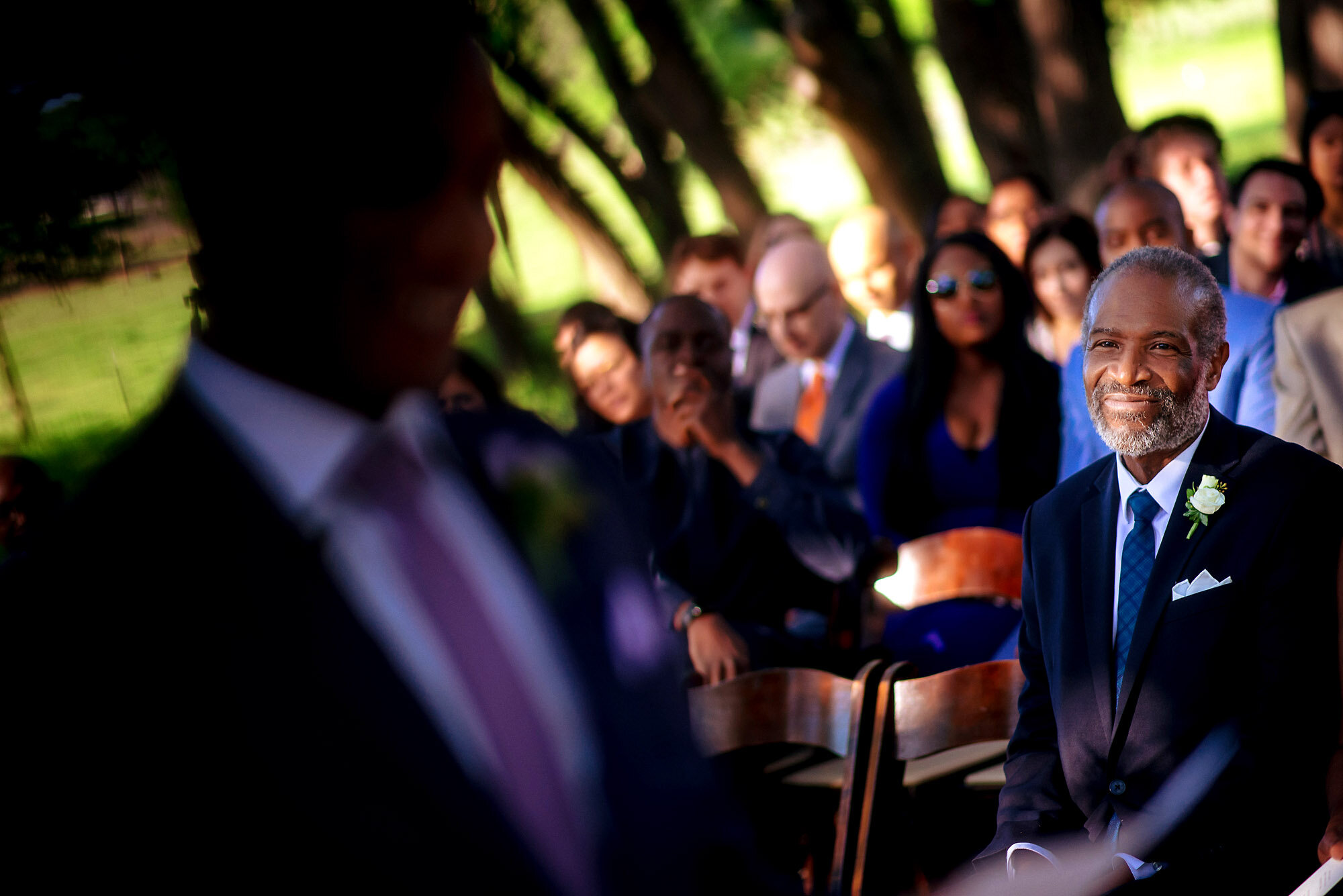 30-Austin-wedding-photographer-Jide-Alakija-father of the groom looking at groom.jpg.JPG