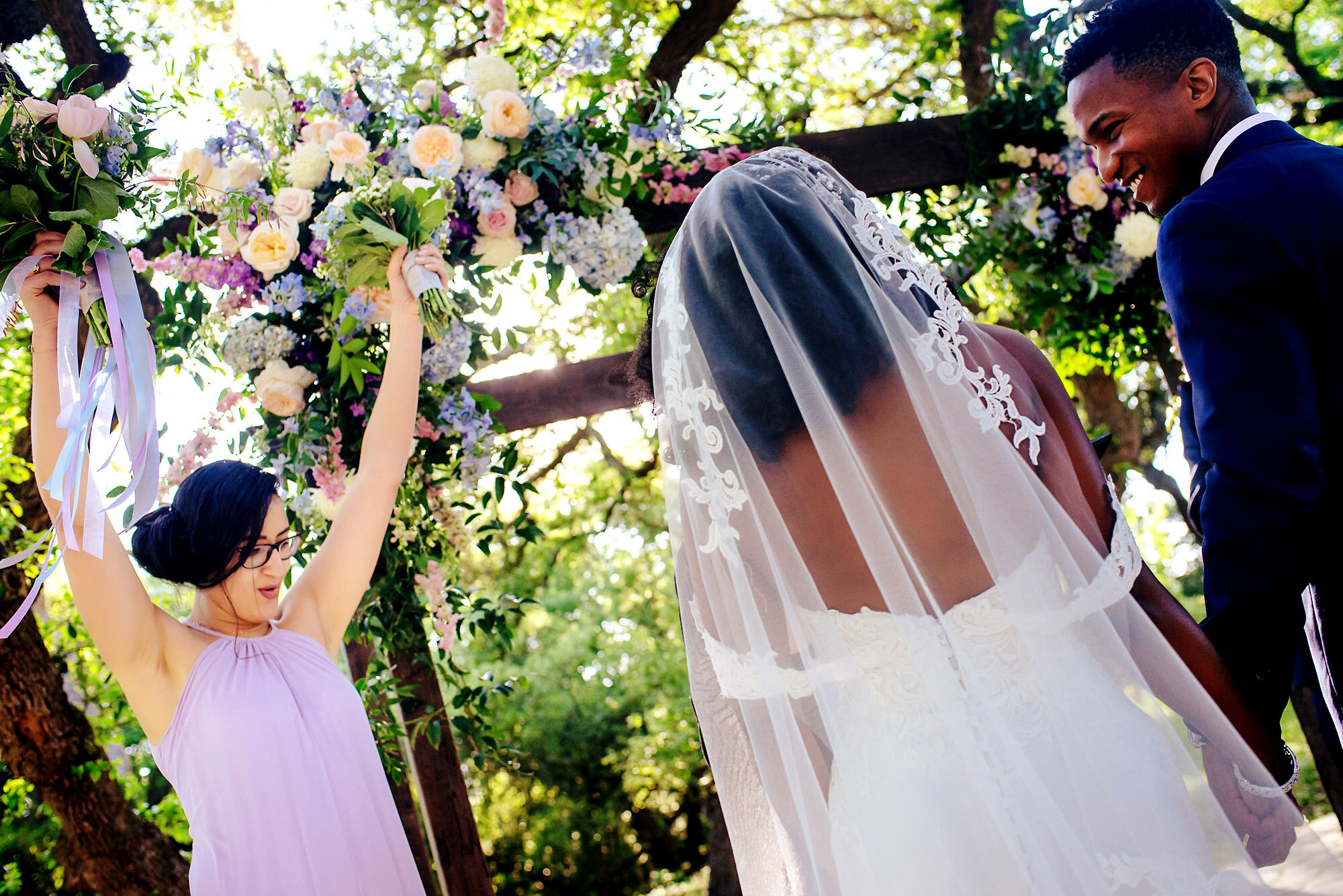 31-Austin-wedding-photographer-Jide-Alakija-maid of honor has hand ups as couple have been pronounced.jpg.JPG