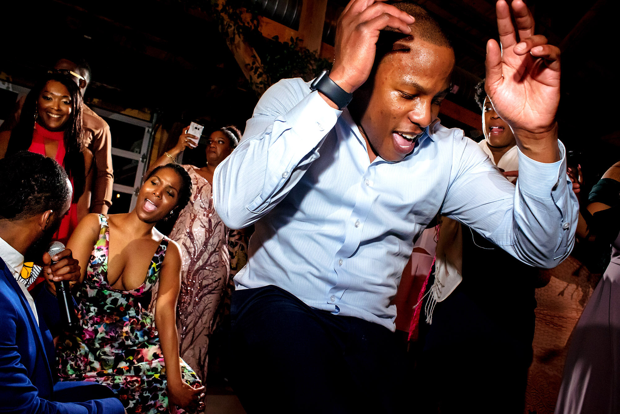 63-Austin-wedding-photographer-Jide-Alakija-guests dancing with their hands up.jpg.JPG