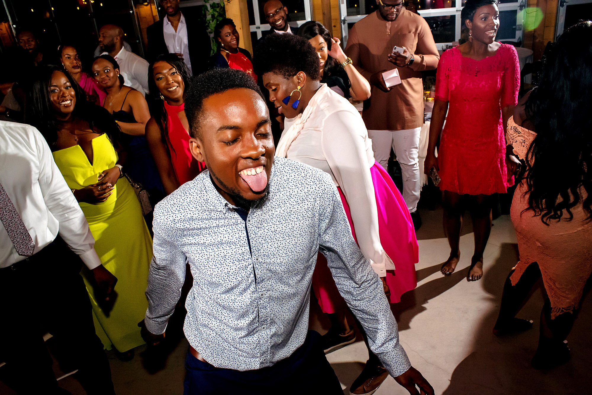 68-Austin-wedding-photographer-Jide-Alakija-guest on the dancefloor with tongue out.jpg.JPG