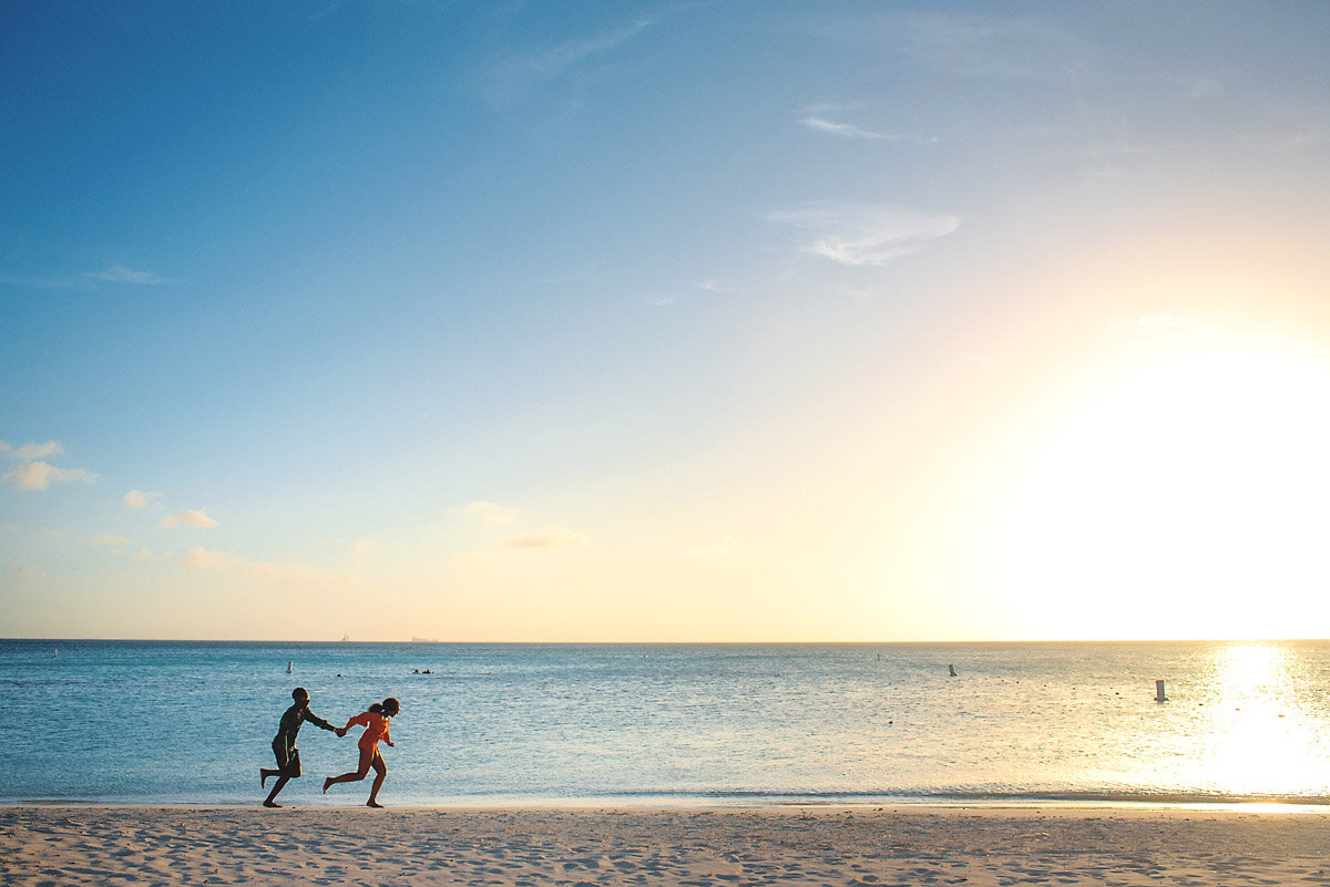05-Aruba-wedding-photographer-Jide-Alakija-couple running along the beach in aruba- engagment shoot.jpg.JPG