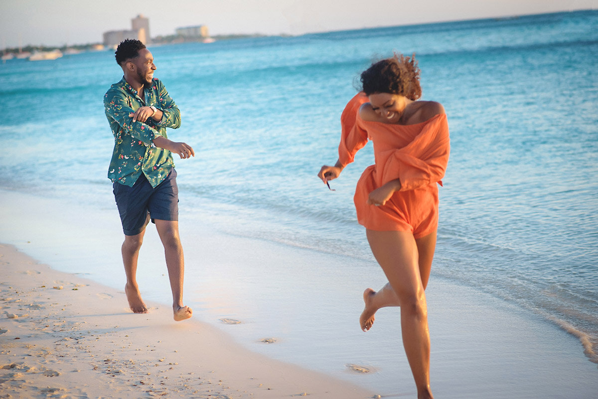 06-Aruba-wedding-photographer-Jide-Alakija-boy chasing girl on beach in aruba- engagment shoot.jpg.JPG