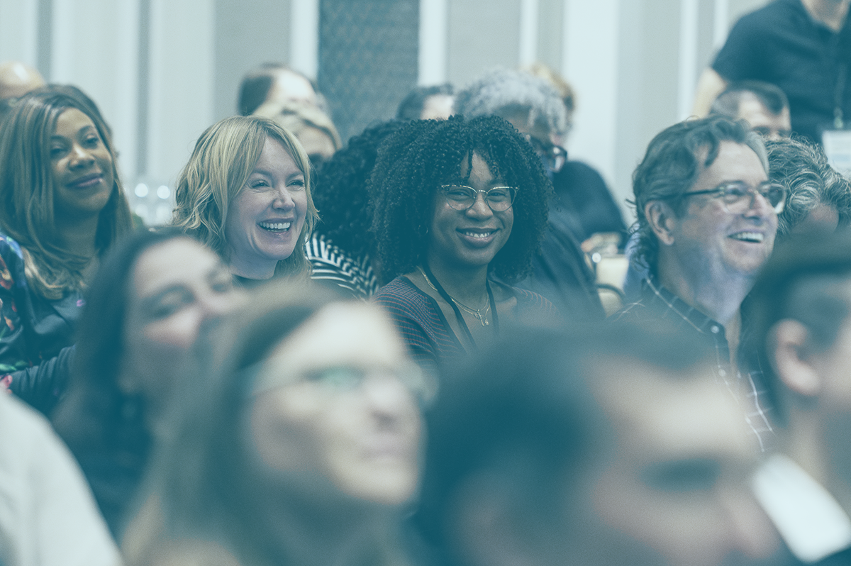 A crowd of smiling people in attendance at the 2023 National Gathering.