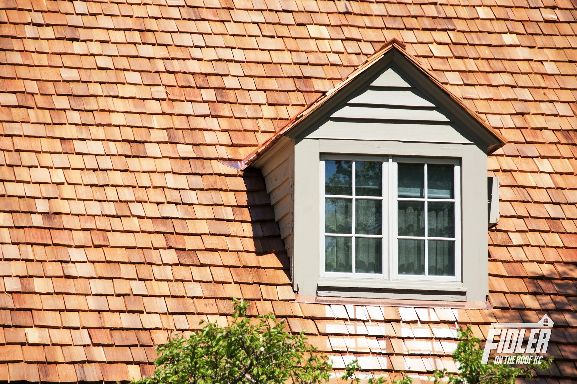 Historic wood shake shingles on a residential roof.