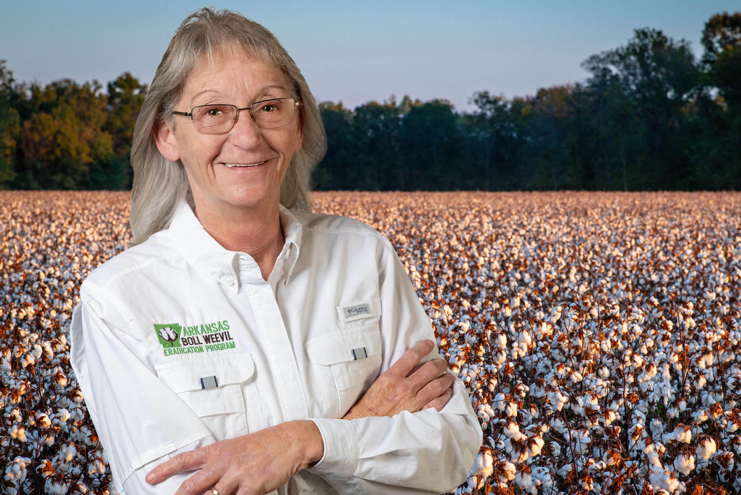 Linda Kelley in white collard shirt in front of cotton field