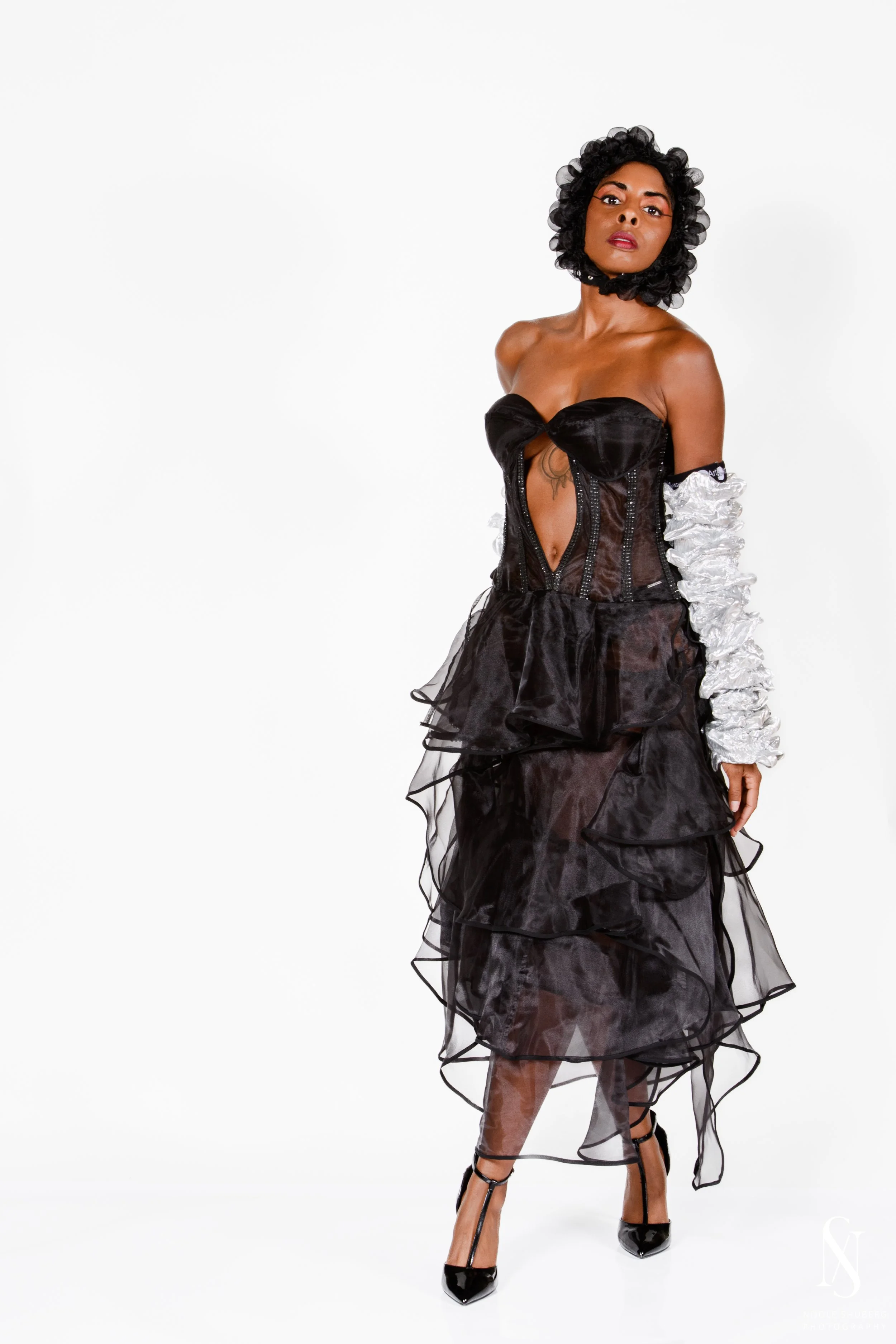 Strapless fitted evening gown featuring a corset structure, tiered skirt, and elegant cutout detail