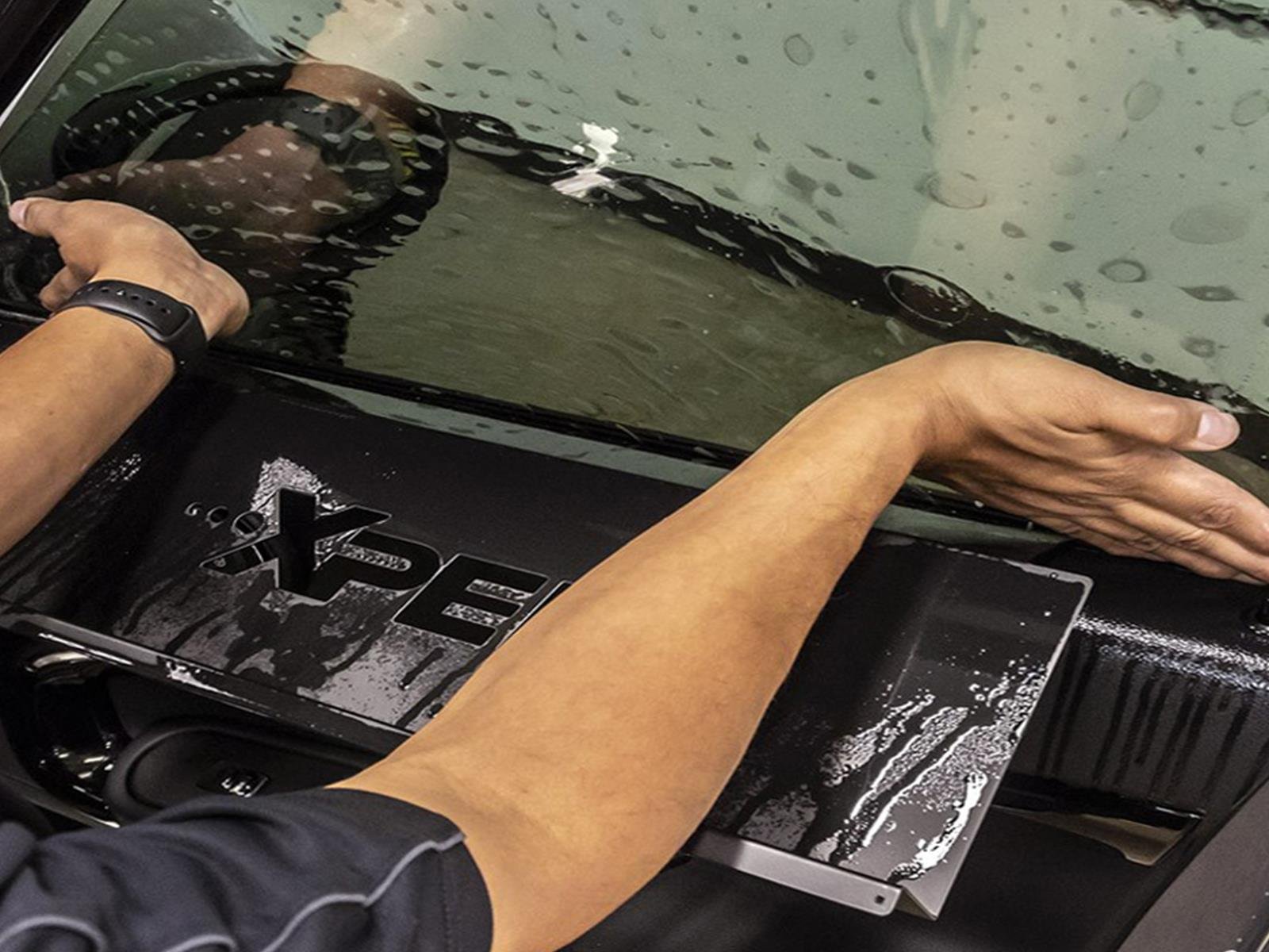 Person applying window tint with Xpel Prime XR