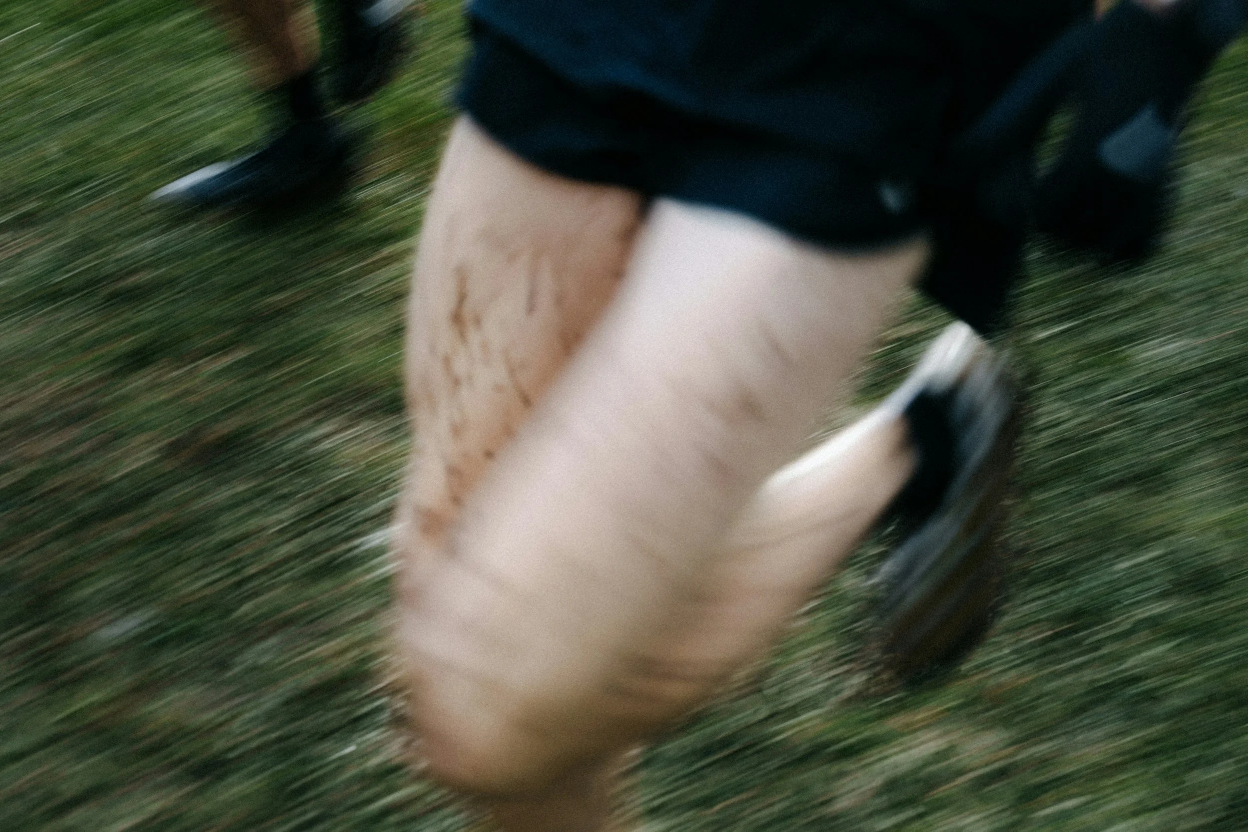 a man running in muddy grass