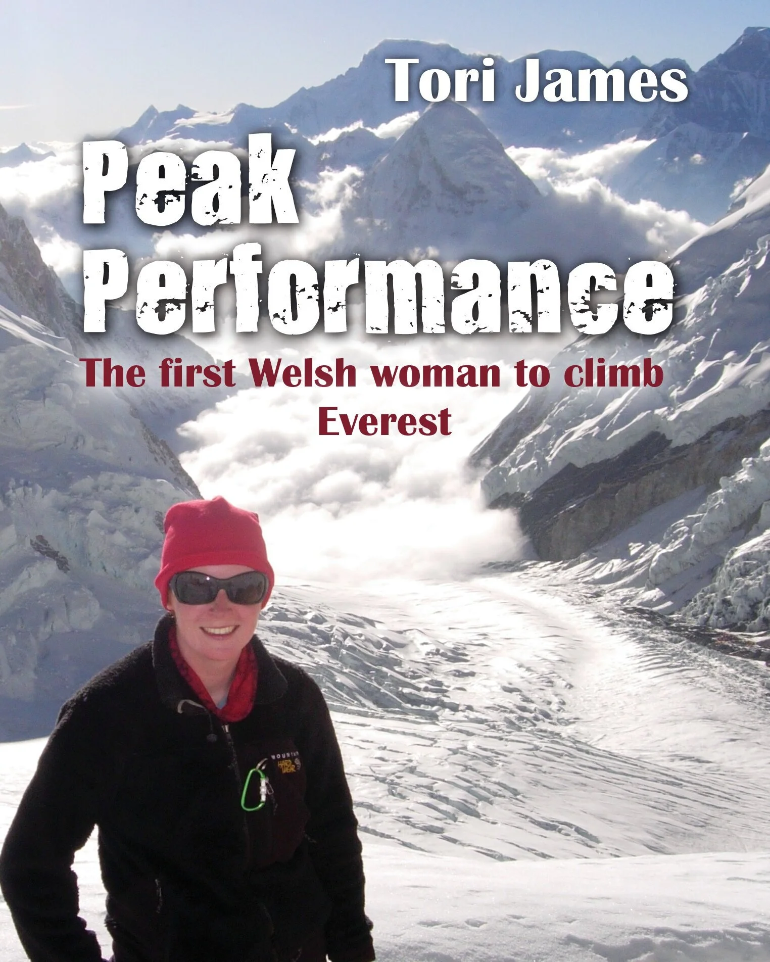 Book cover of Tori James memoir published Peak Performance The First Welsh Woman to Climb Everest. Tori is pictured on the cover wearing a black jacket, red hat and sunglasses, with Mount Everest behind her.