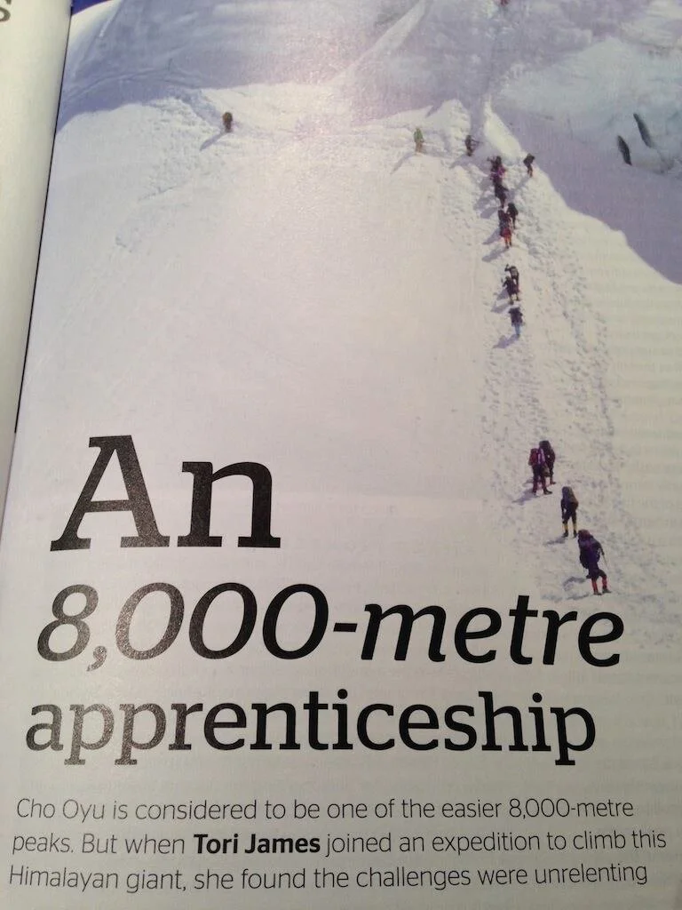 Geographical Article Ch Oyu showing climbers ascending a steep mountain side in the snow