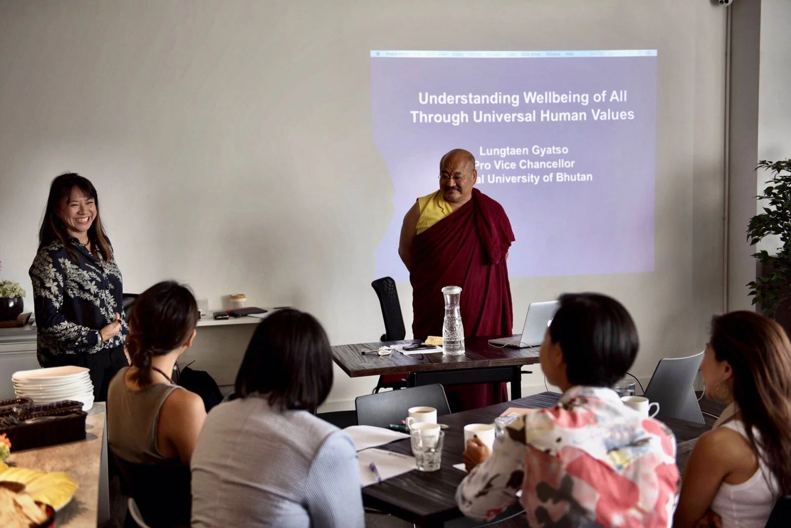 Khenpo presenting to friends of  {embrace} worldwide 