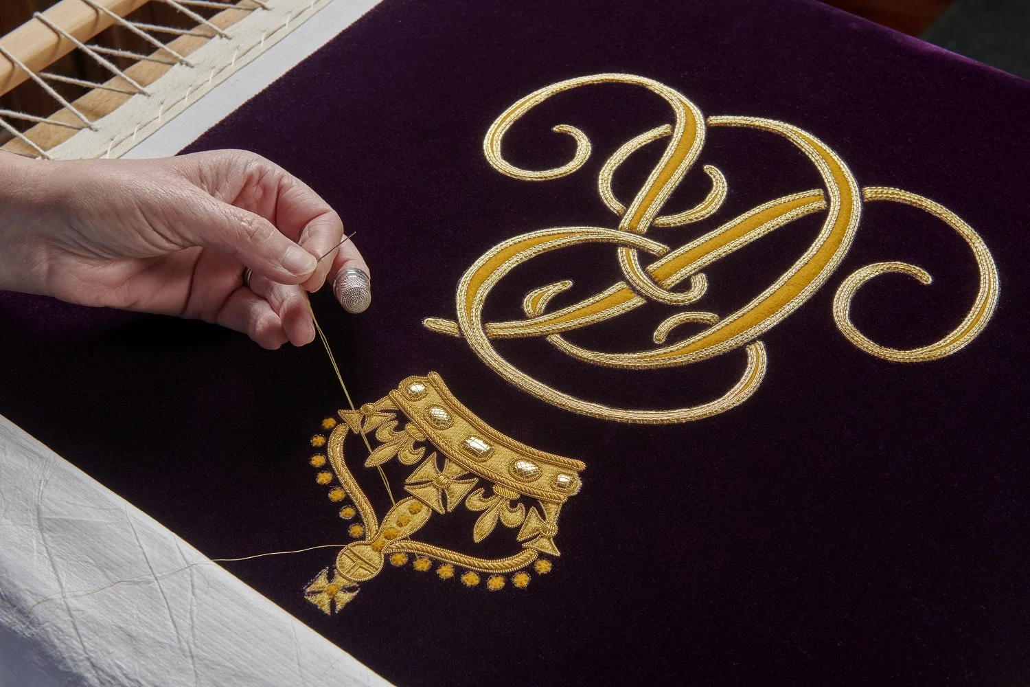 Royal-School-of-Needlework-Embroidery-Studio_work-in-progress-of-Queens-Cypher-on-HMQC-Robe-of-Estate-1500px.jpg