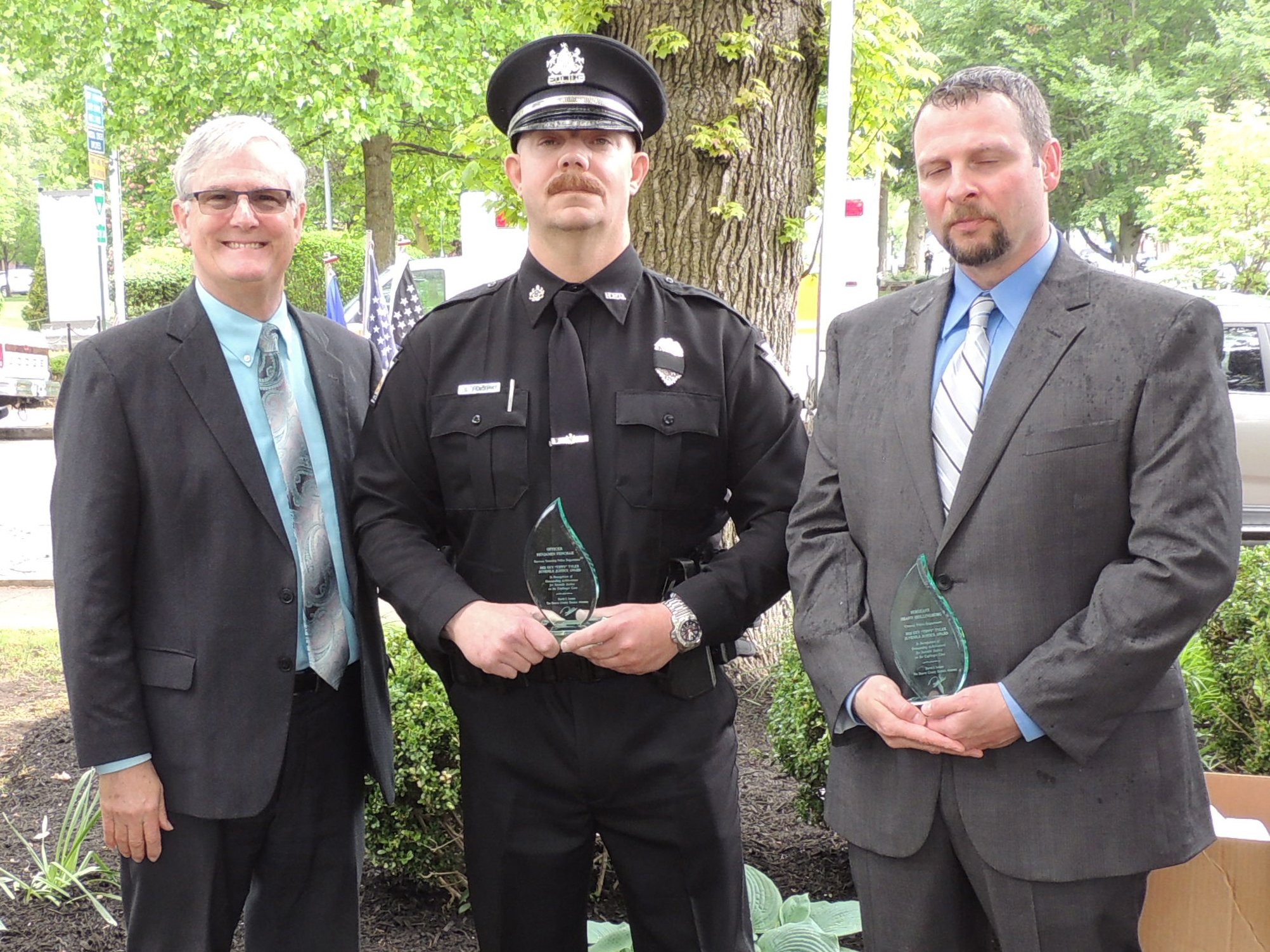 District Attorney David Lozier presents the Sergeant Guy "Tippy" Tyler Award to Officer Benjamin Fenchak, Raccoon Twp. Police Department, and Sergeant Shawn Shillingburg, Conway Police Department. 