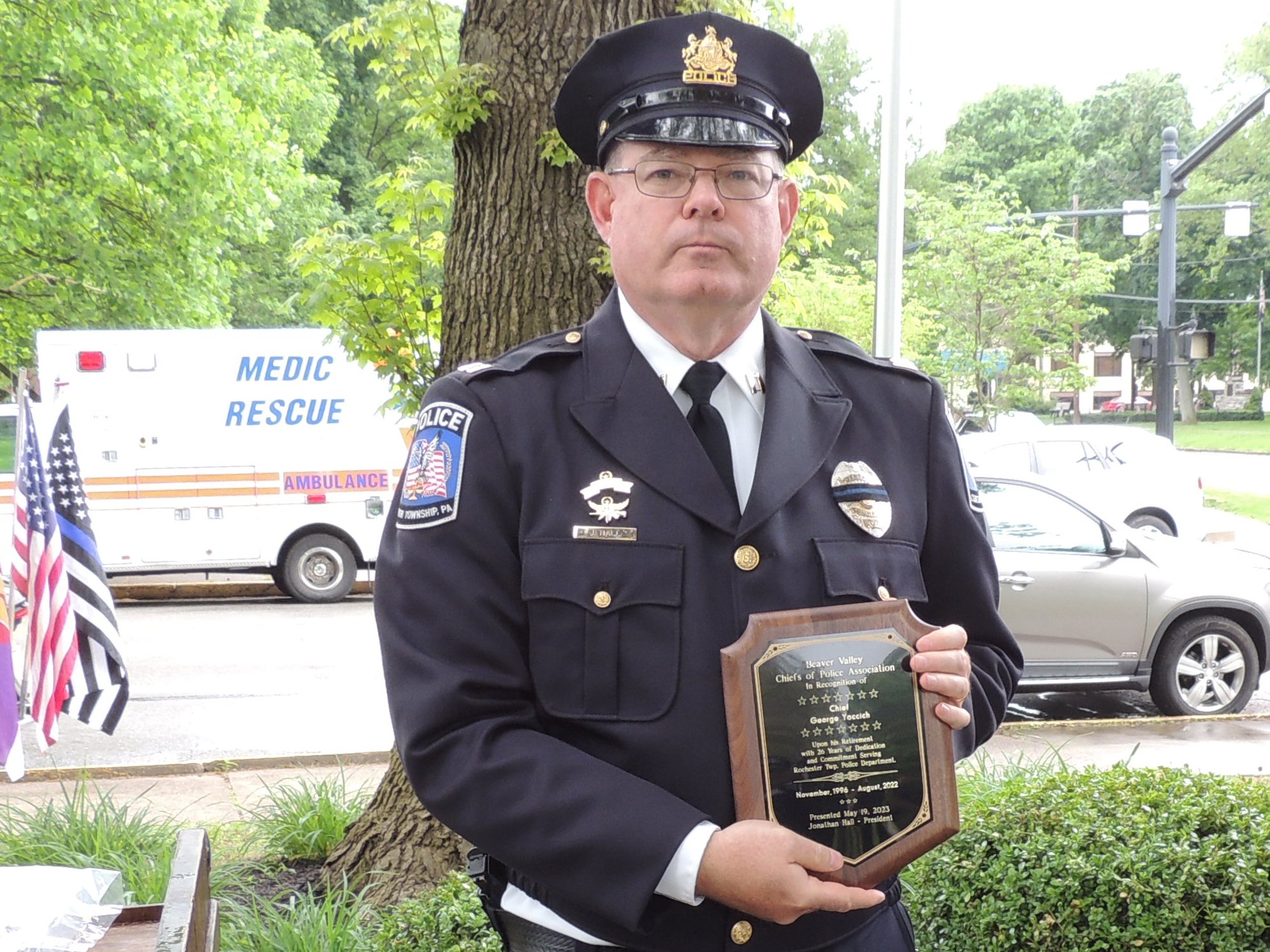 Captain Jonathan Hall displays Chief George Yaccich's (not pictured) retiree plaque for his 26 years of service to Rochester Township Police Department.