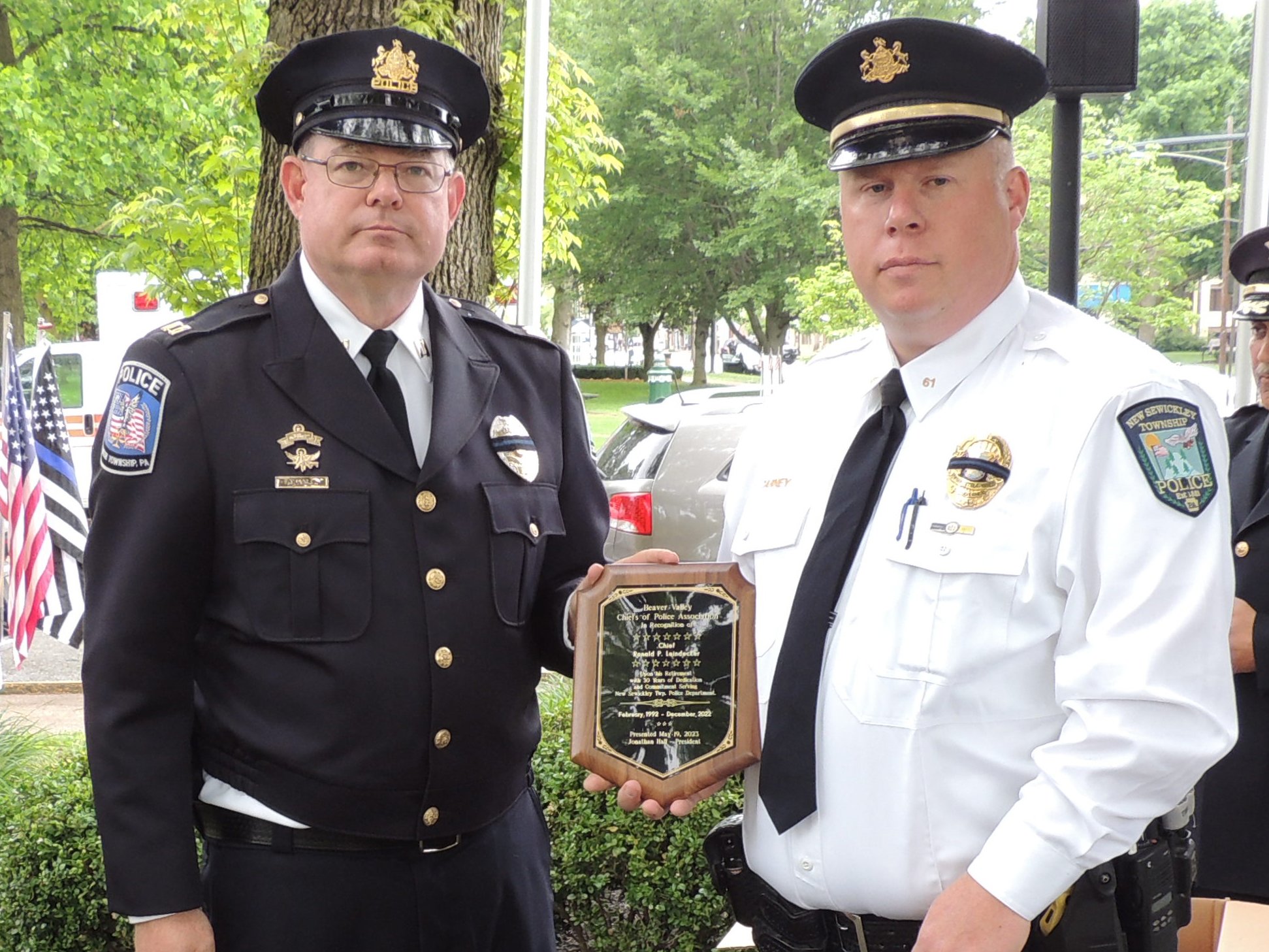 Captain Jonathan Hall presents Chief Ronald Leindecker's (not pictured) retiree plaque for his 30 years of service to New Sewickley Twp. Police Dept. Current Chief Greg Carney accepted on his behalf.