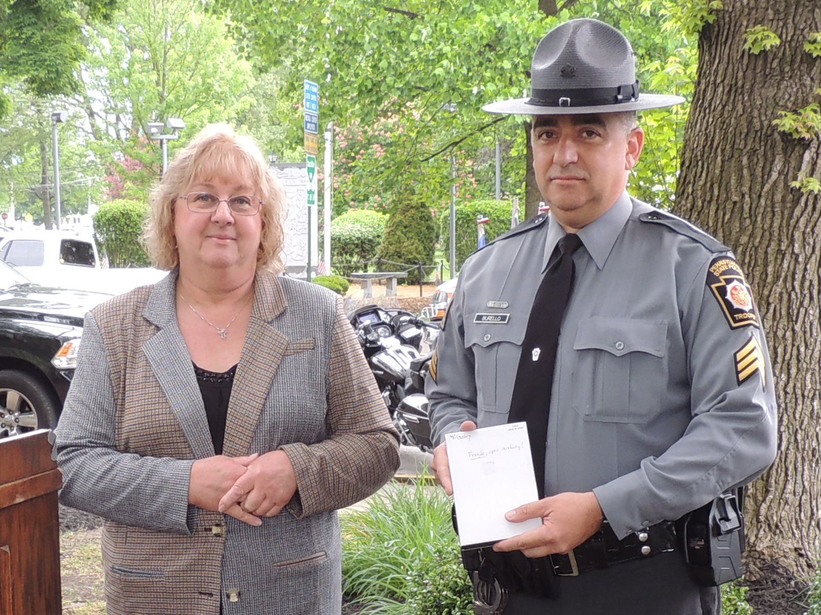 Advocacy Coordinator Millie Anderson presents an award for exemplary service in handling sexual assault cases for State Trooper Clayton McGeary. Accepting on his behalf is State Trooper Bufello.