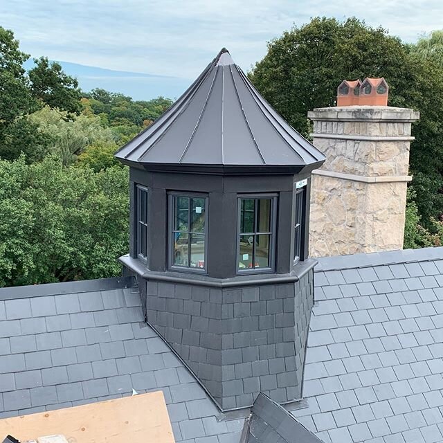 Finishing touches on this Unfading black slate and black zinc custom cupola with zinc crown moulding and zinc bullnose window sill flashings. #slateroofing #zinc roofing #decorative cupola