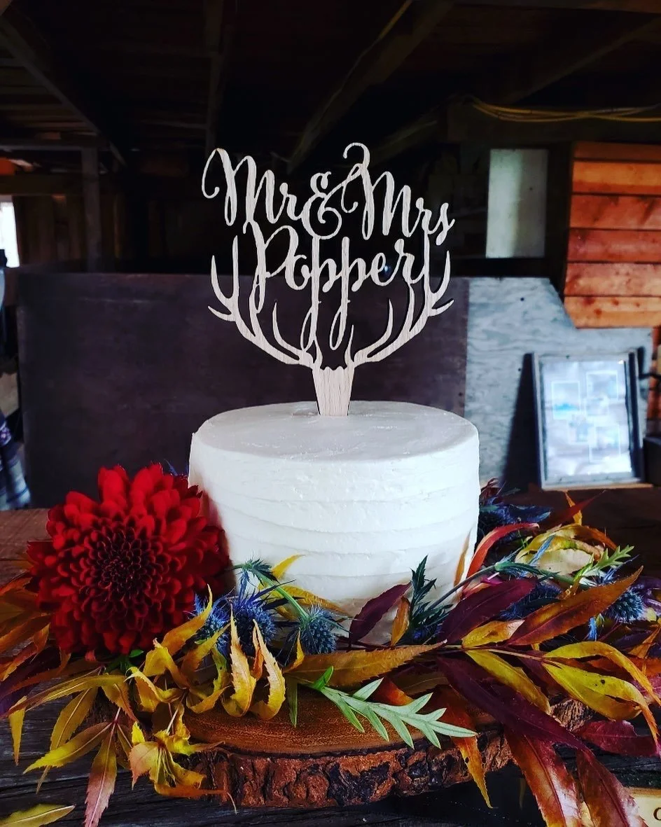 single tier cake with fresh flowers and foliage.JPG