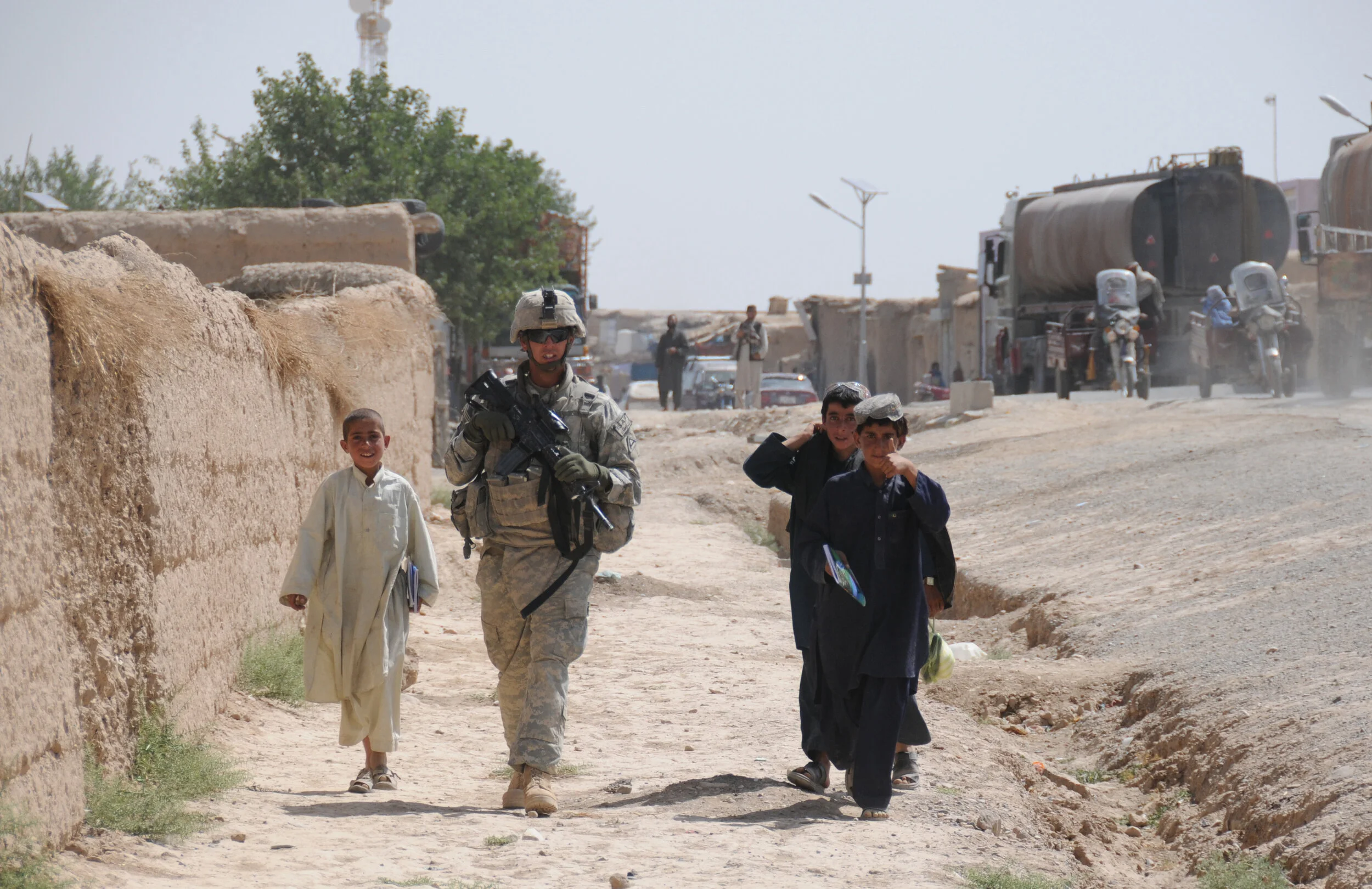 Defense.gov_News_Photo_100627-A-1619C-264_-_Afghan_children_walk_alongside_U.S._Army_Spc._Steven_London_from_2nd_Platoon_Delta_Company_1st_Battalion_4th_Infantry_Regiment_U.S._Army.jpg