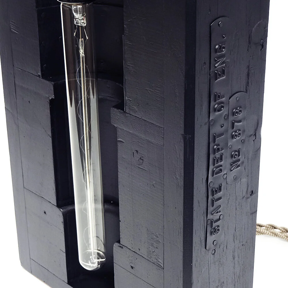 Migliodesign - Black Knight accent light with State Department metal ID tag on the side
