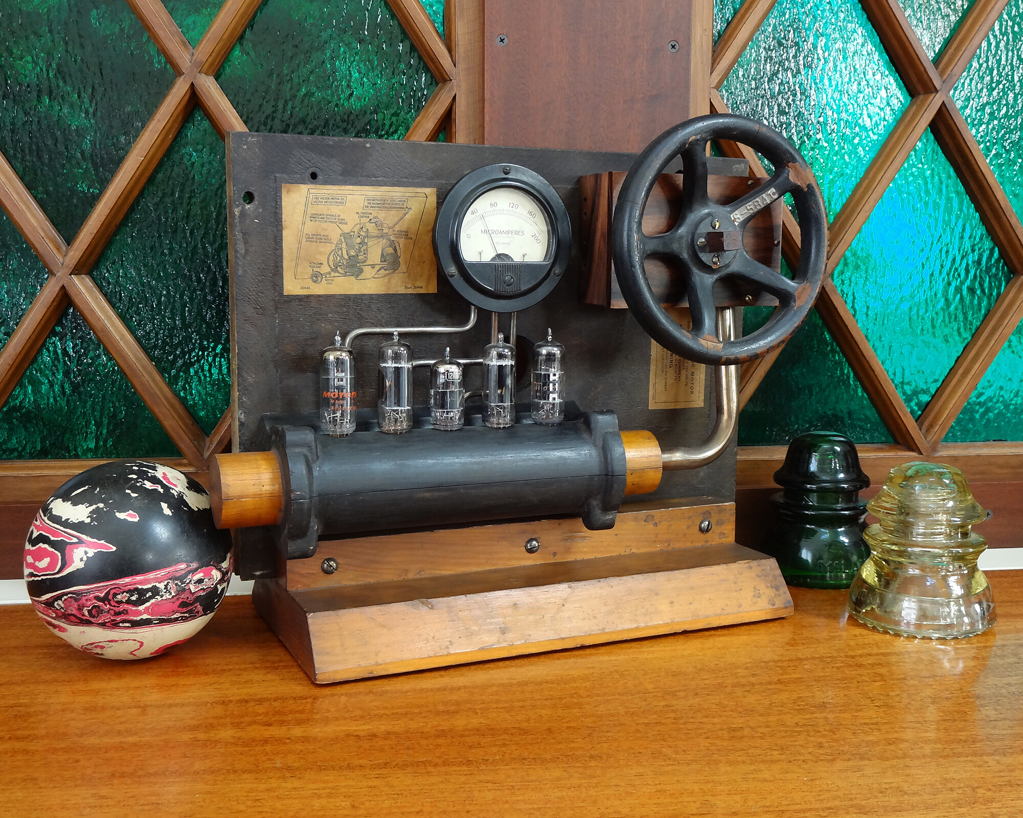 Steampunk Mystery Device with Wood Foundry Molds and Vacuum Tubes shown on a table