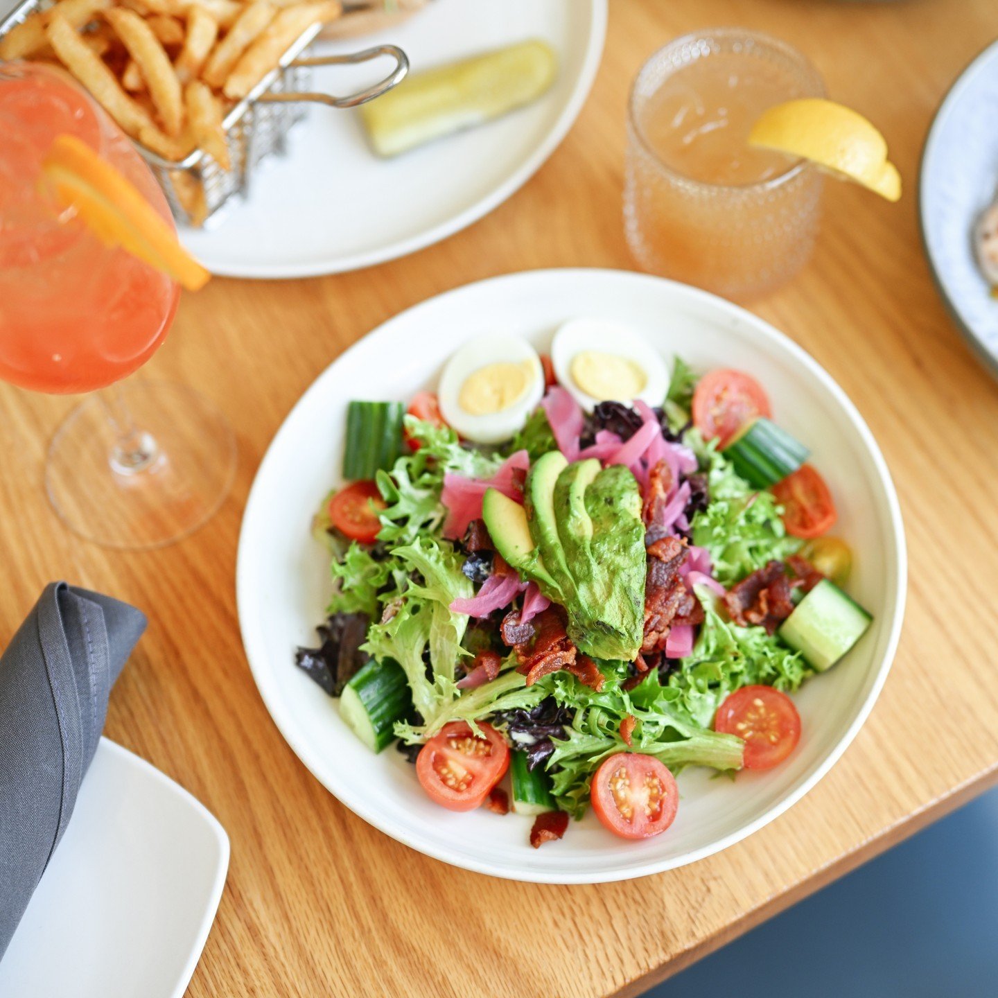 Here at The Cottage, we're all about fresh, clean, and green &ndash; and our Cottage Cobb salad is just that!⁠
⁠
A wholesome mix of flavors, featuring boiled eggs, creamy avocado, tomatoes, tangy pickled onions, cucumbers, bacon, all tied together wi