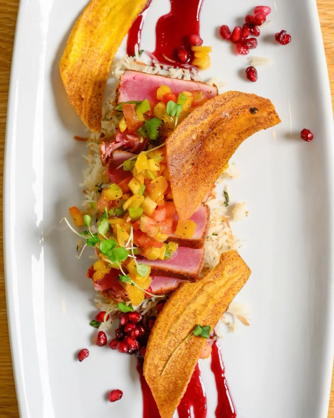 From La Jolla to Wellesley!

Meet our La Jolla Spiced Ahi Tuna*. Complete with fried plantain, coconut rice, pom reduction, papaya &amp; mango salsa.