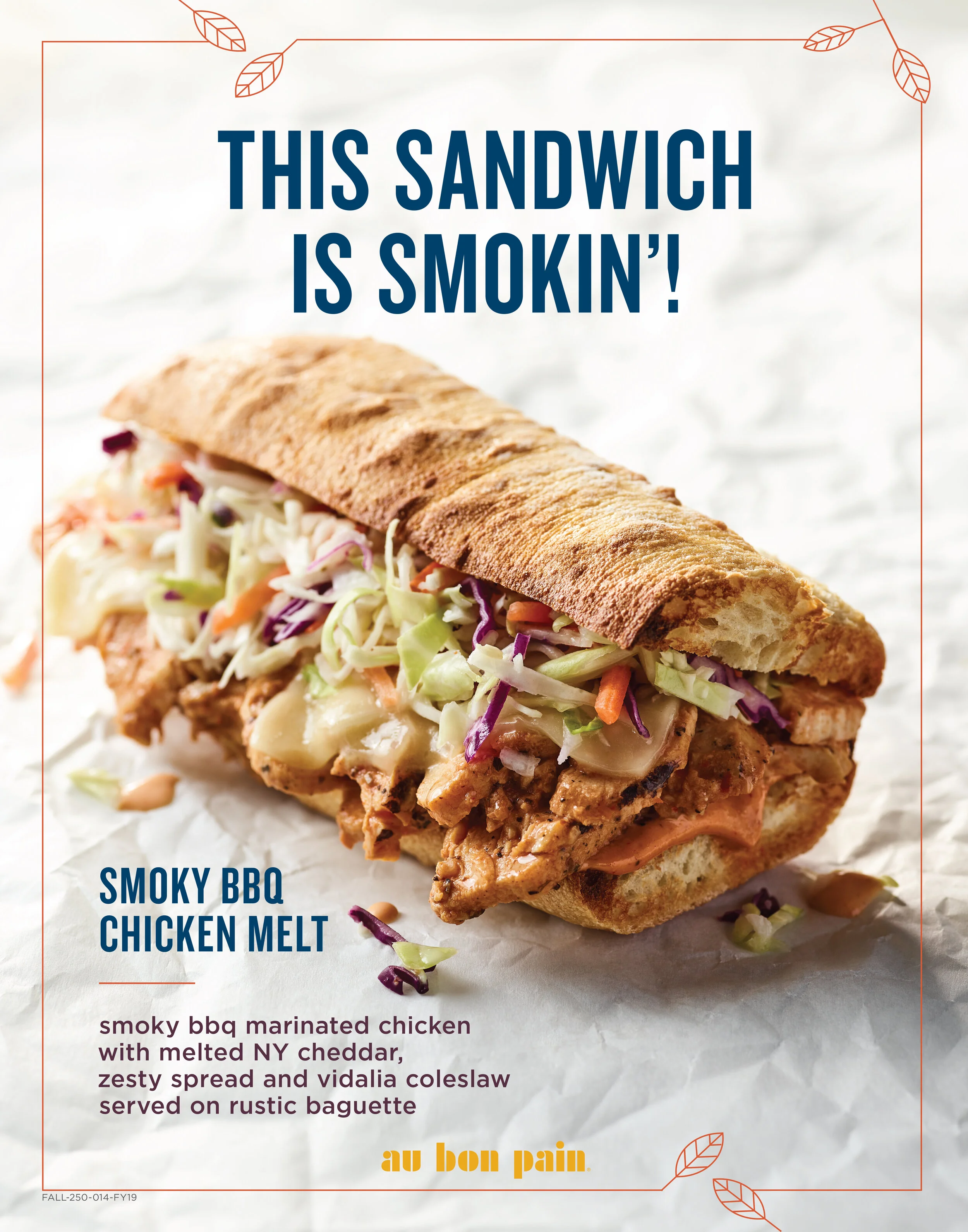 Close-up of a smoked BBQ chicken melt sandwich on a rustic baguette with coleslaw and melted cheddar cheese, with text overlay reading 'This Sandwich Is Smokin!' In-Store poster for Au Bon Pain Cafe