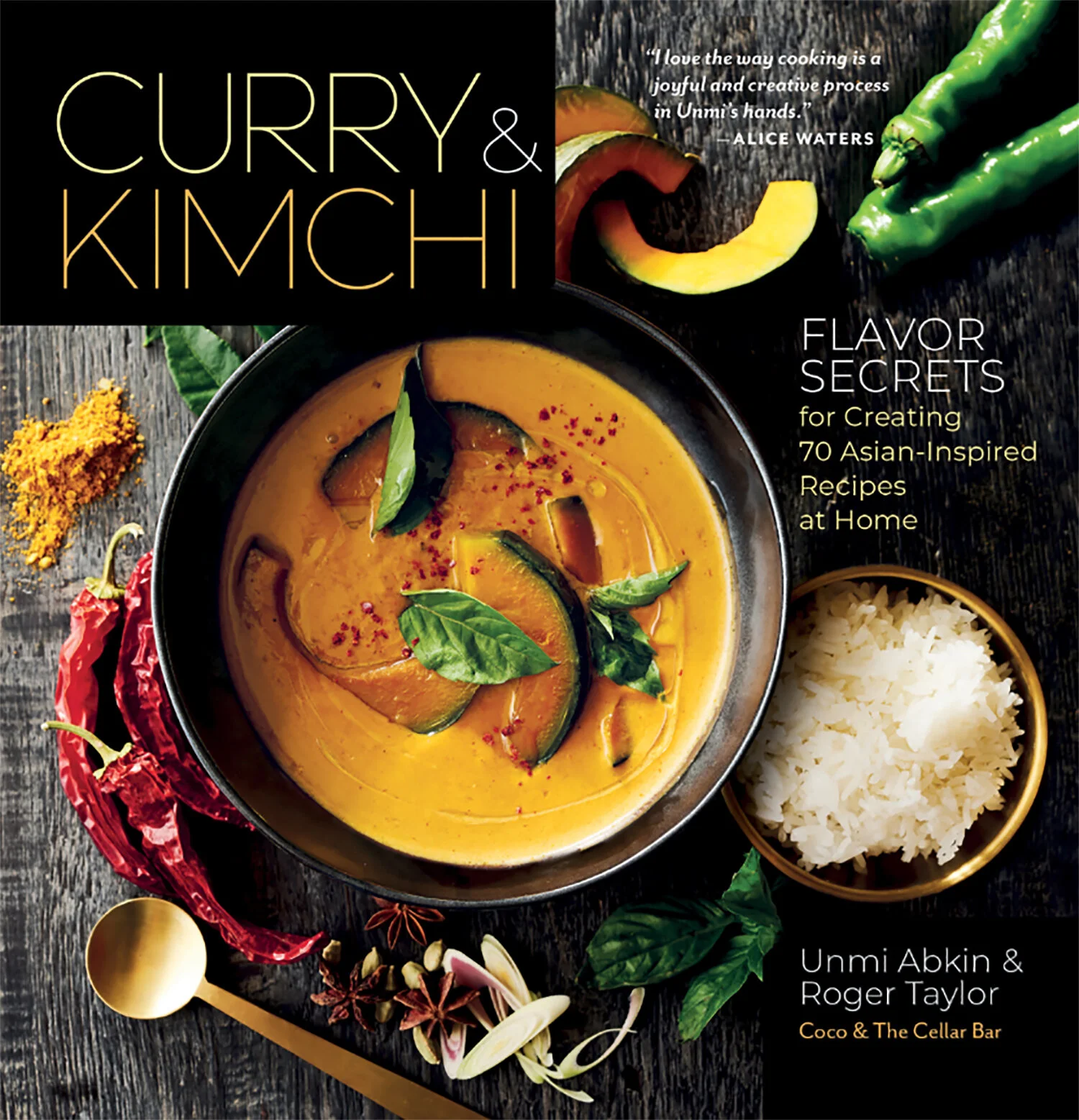 Cover of the book titled "Curry & Kimchi" featuring a bowl of yellow curry with green herbs and sliced vegetables, alongside a bowl of white rice, with spices and chili peppers on a rustic wooden surface.