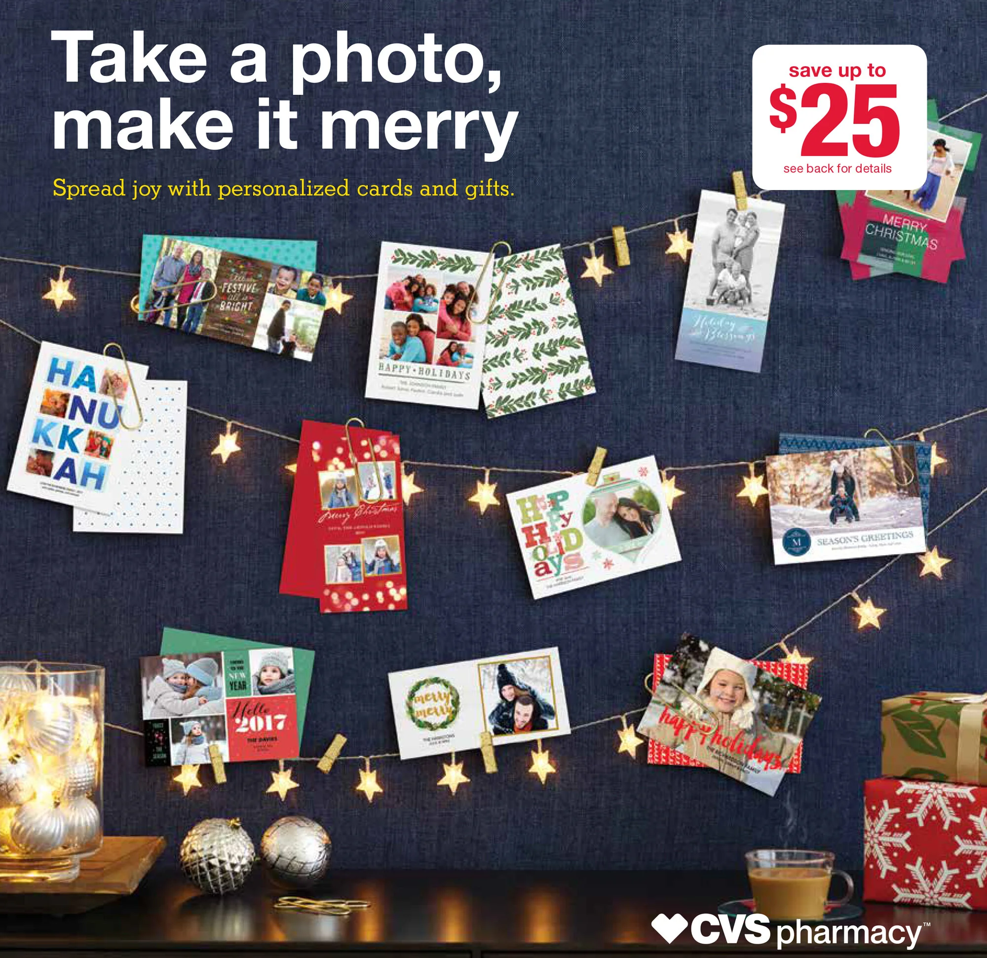 Multiple holiday greeting cards and photos hanging on string with star-shaped lights, holiday decorations, and gifts on a dark background, promoting personalized photo cards at CVS pharmacy.