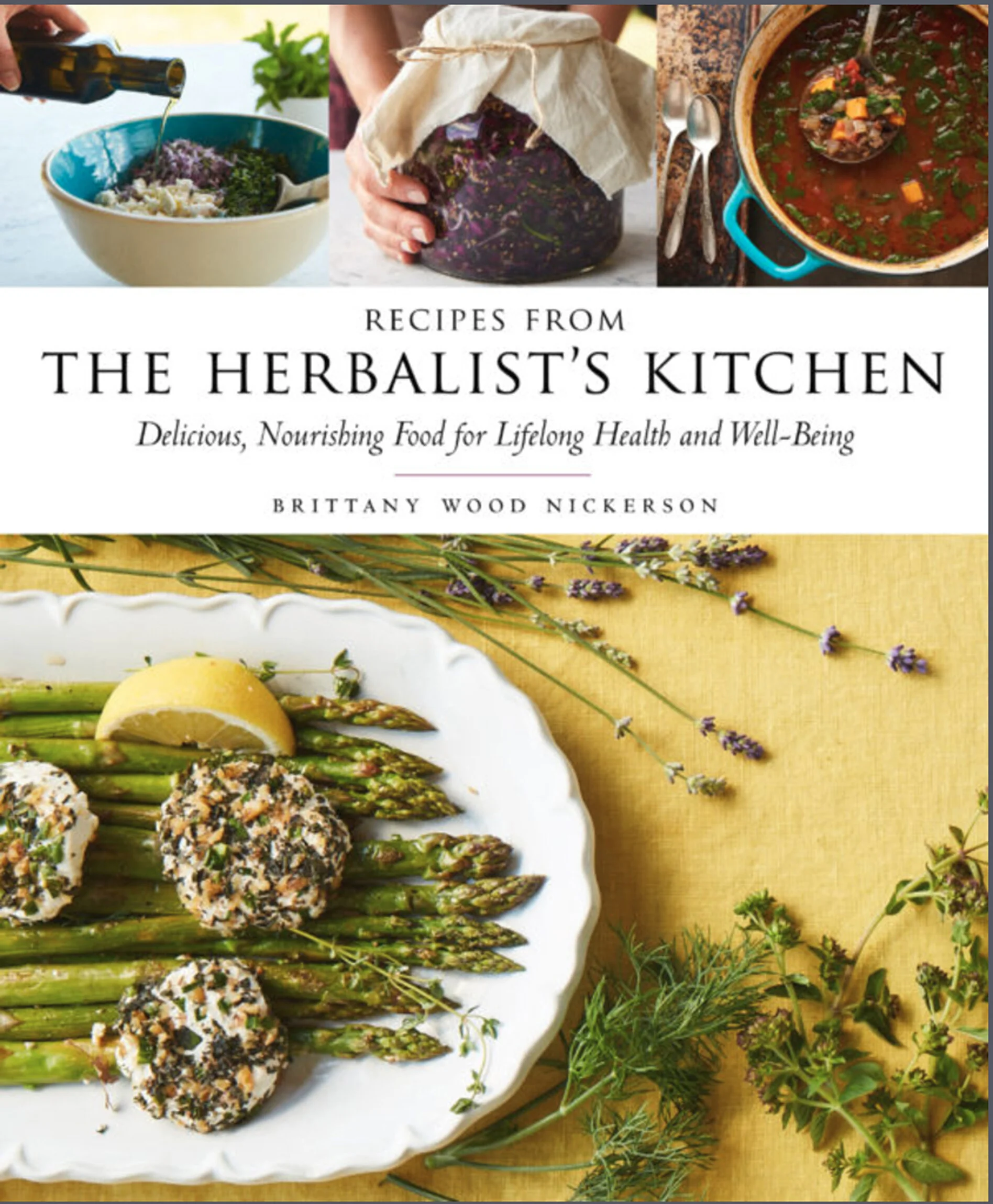 Cover of the cookbook 'Recipes from The Herbalist's Kitchen' featuring a plate of asparagus and lemon slices topped with cheese and herbs, surrounded by sprigs of herbs and lavender flowers.