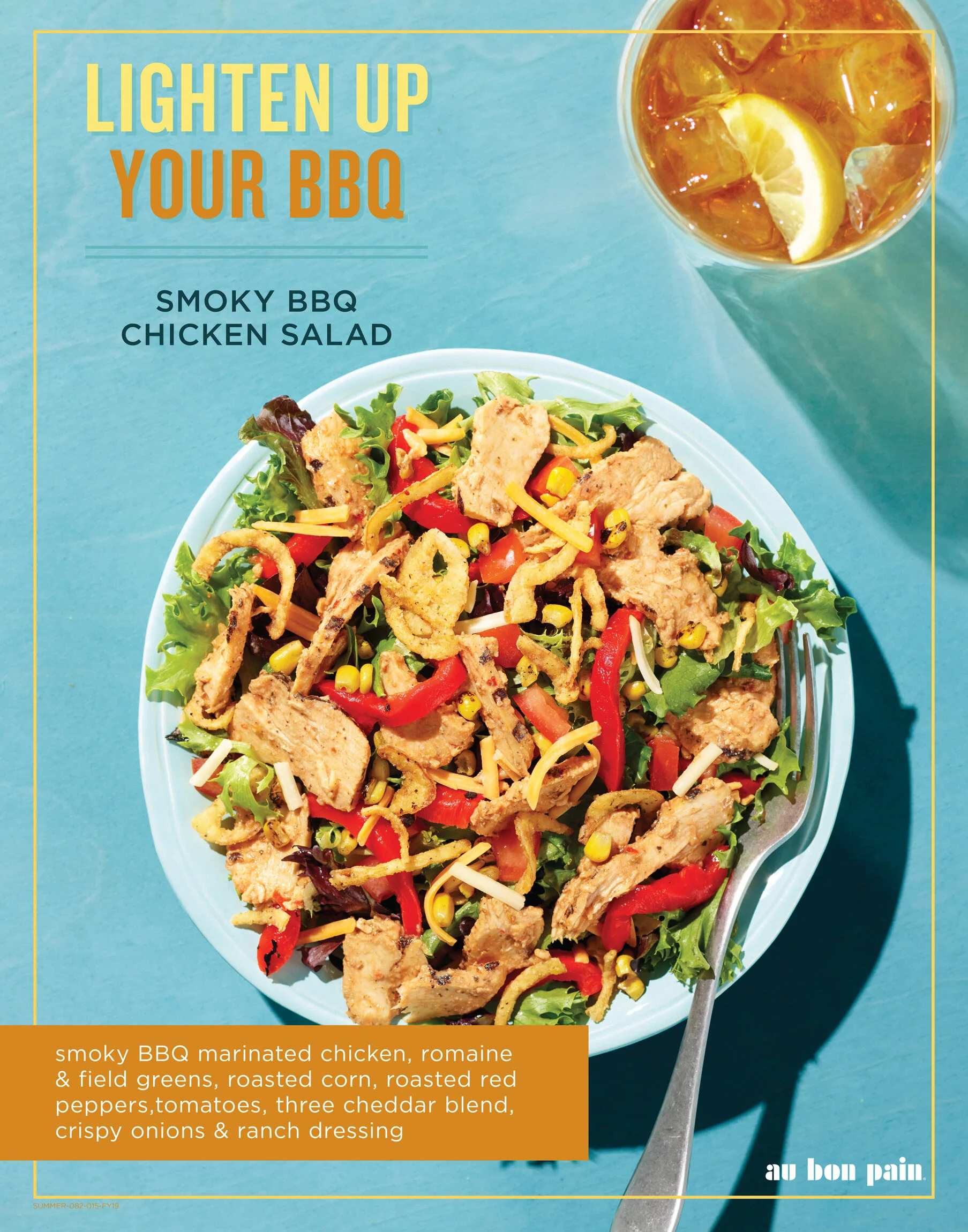 A plate of smoky BBQ marinated chicken salad with field greens, roasted corn, roasted red peppers, tomatoes, cheddar blend, crispy onions, and ranch dressing. A fork rests on the plate. In the background, there is a glass of iced tea with lemon slice