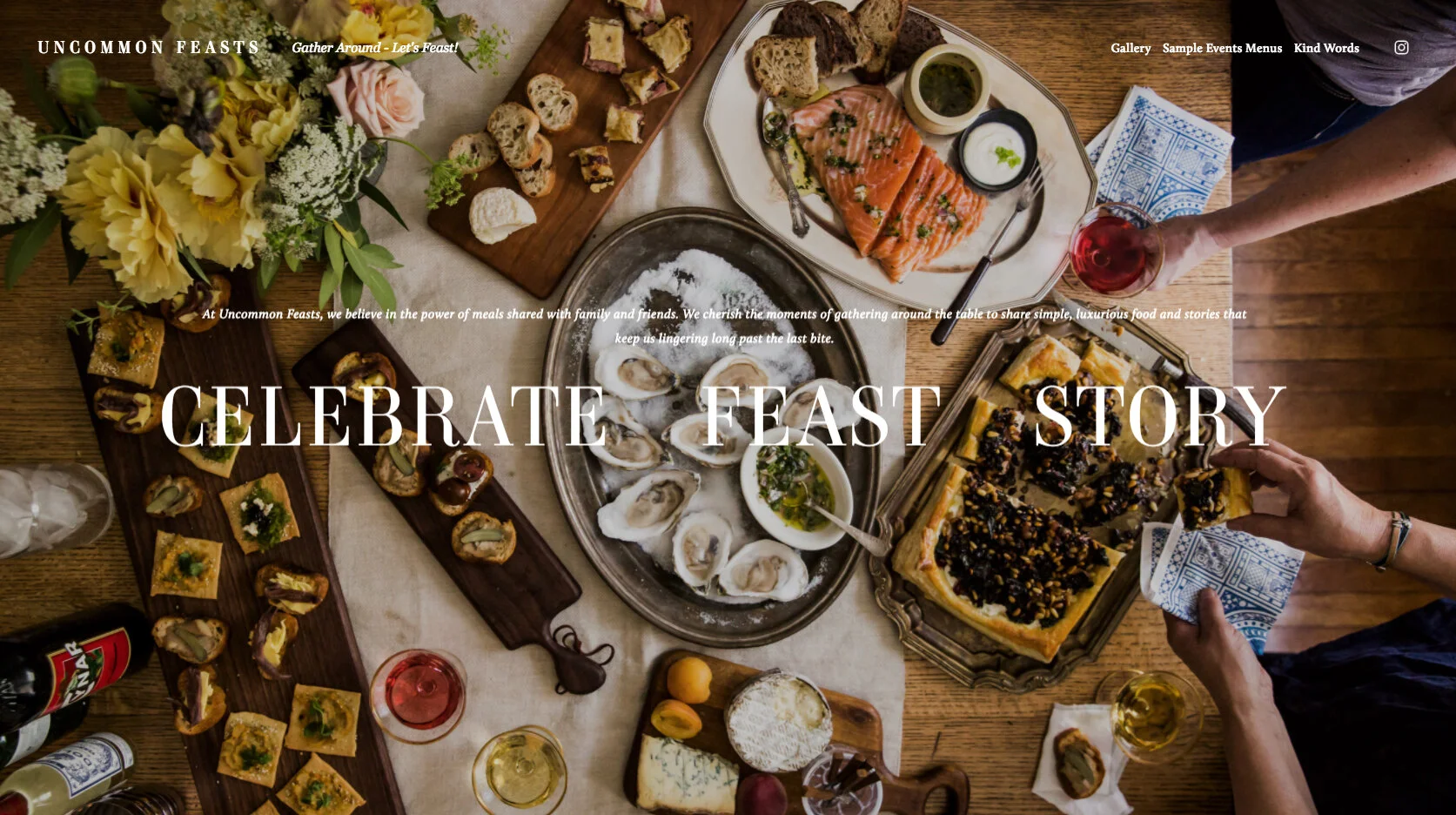 A variety of food on a wooden table, including oysters, smoked salmon, bread, cheese, appetizers, and drinks; surrounded by flowers and a person reaching for a slice of pizza.
