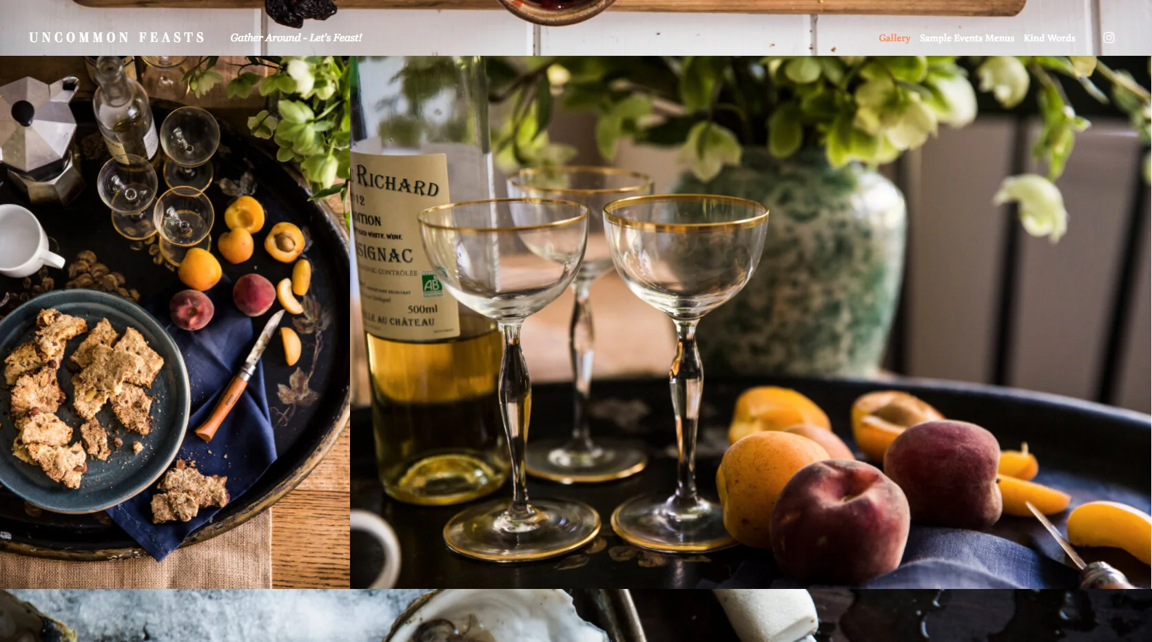 A table setting with leftover food and drinks, including a bottle of white wine, three empty wine glasses with gold rims, peaches, yellow bell peppers, and a large vase with white flowers in the background.