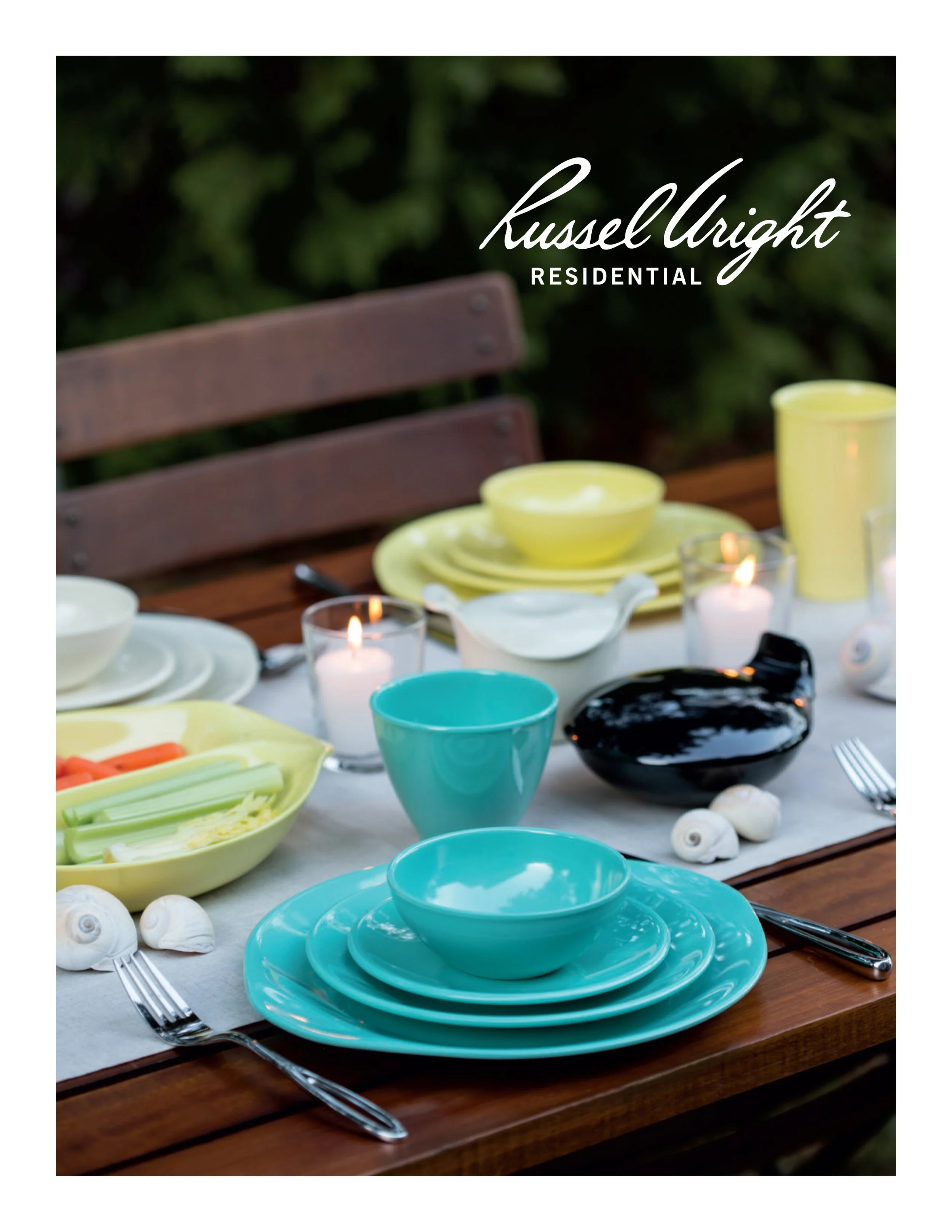 Outdoor dining table set with colorful plates, bowls, cups, candles, and seashells, with a blurred green leafy background, featuring a logo for Russell Wright Residential.