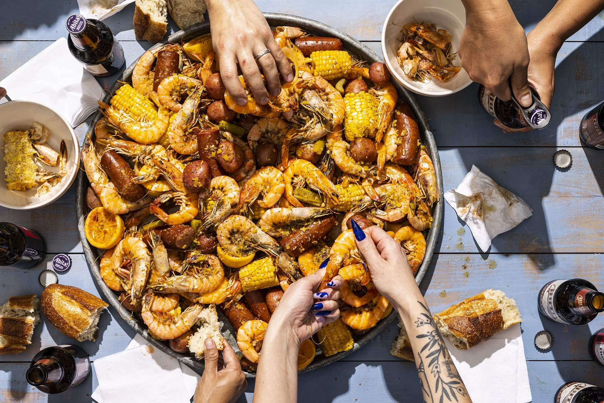 Boston food photographer. People eating a shrimp boil. Overhead view.
