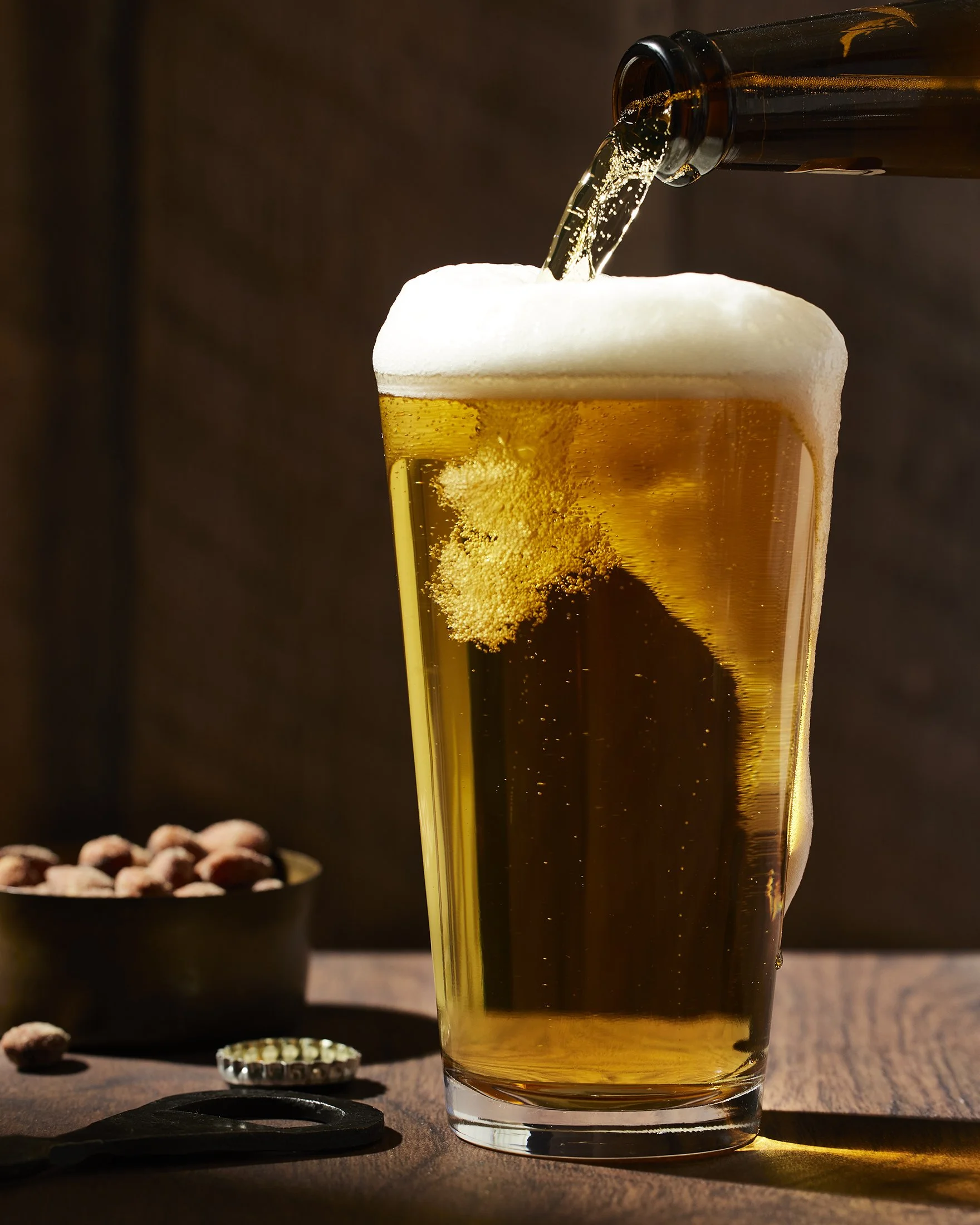 Pouring a pilsner. Boston based food and hospitality photographer. Beverage photography.