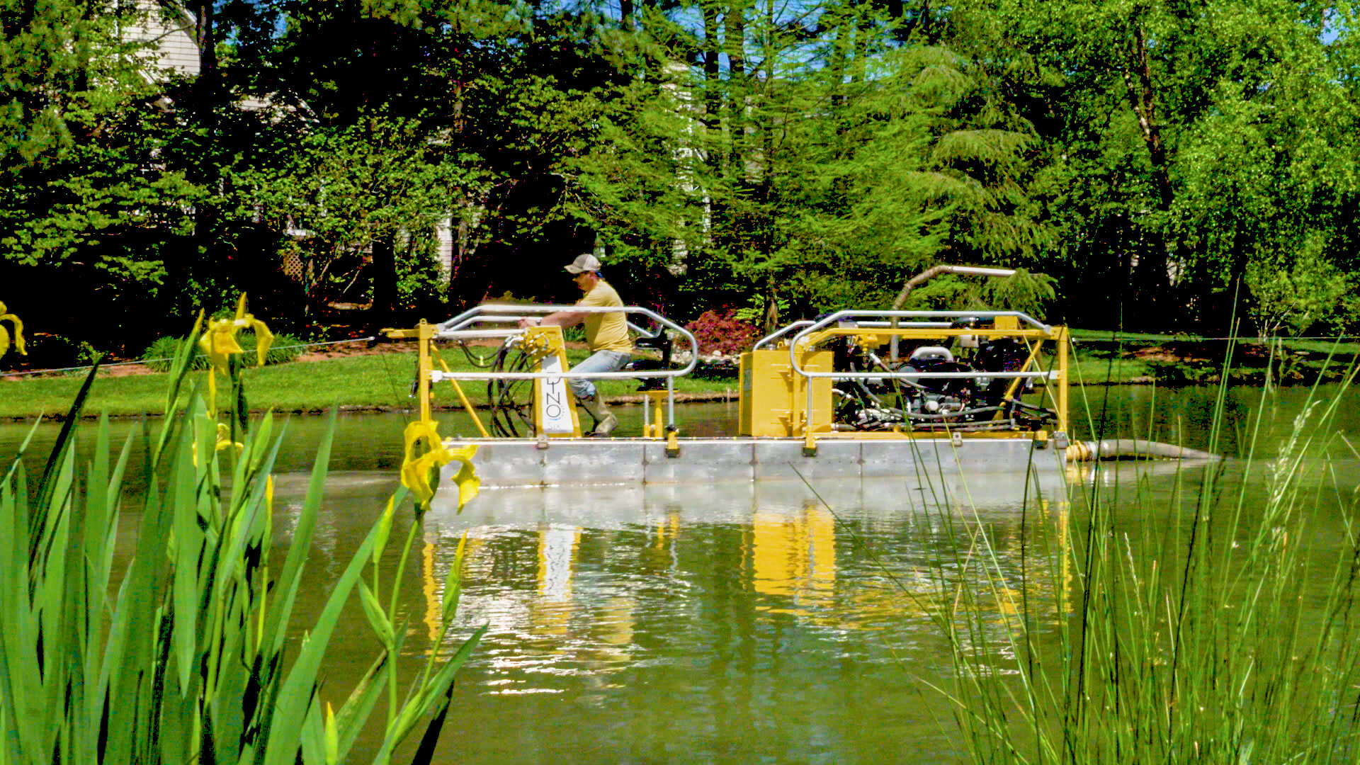 Dragonfly stormwater management expert operates a hydraulic dredge to remove accumulated sediment from an HOA retention pond.