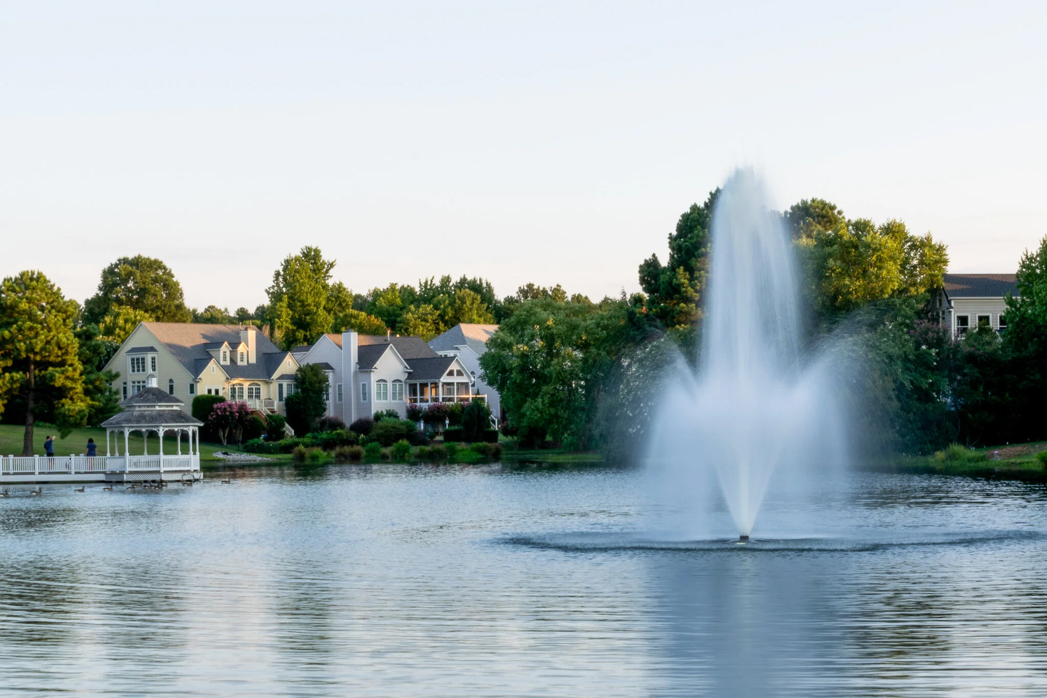 HOA community pond with operational fountain aeration system — Carolina Forest pond management