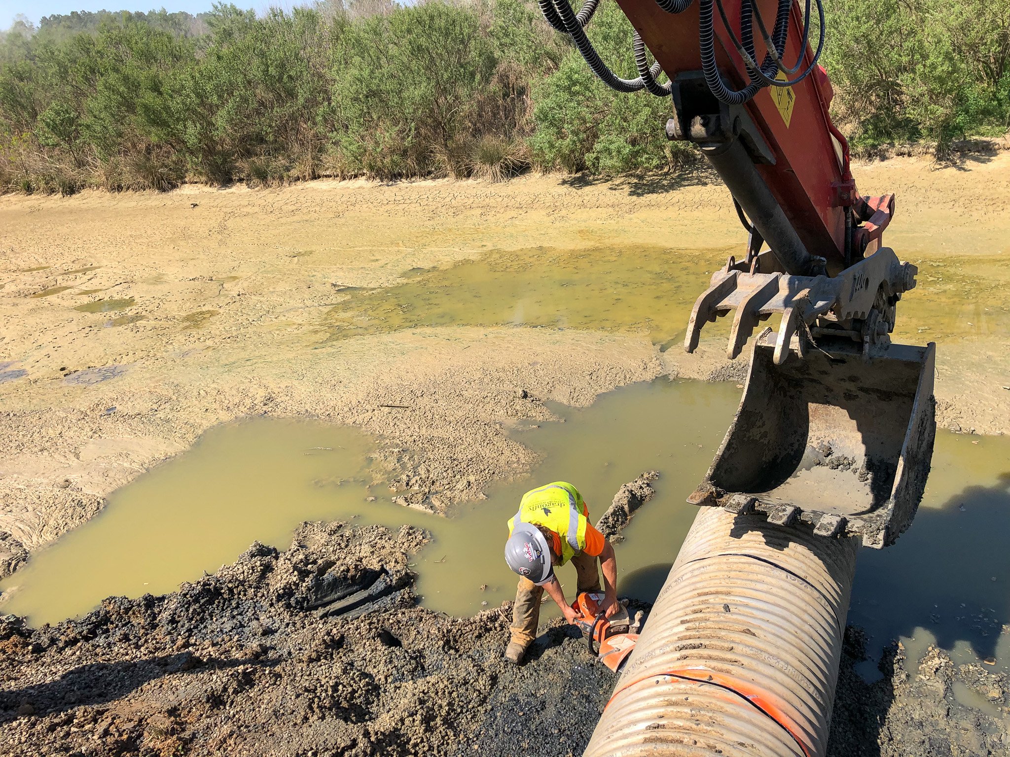 Stormwater repair expert removes a failed BMP pipe during a pipe replacement project.