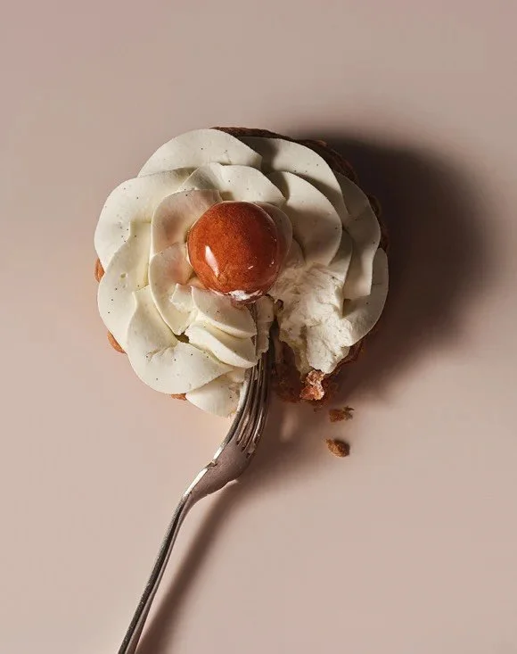 The St. Honor&eacute; is a classic, intricate French dessert named after the patron saint of bakers, featuring a puff pastry base, a caramel-glazed cream puff (choux pastry), and a filling of cr&egrave;me Chiboust (pastry cream lightened with meringu