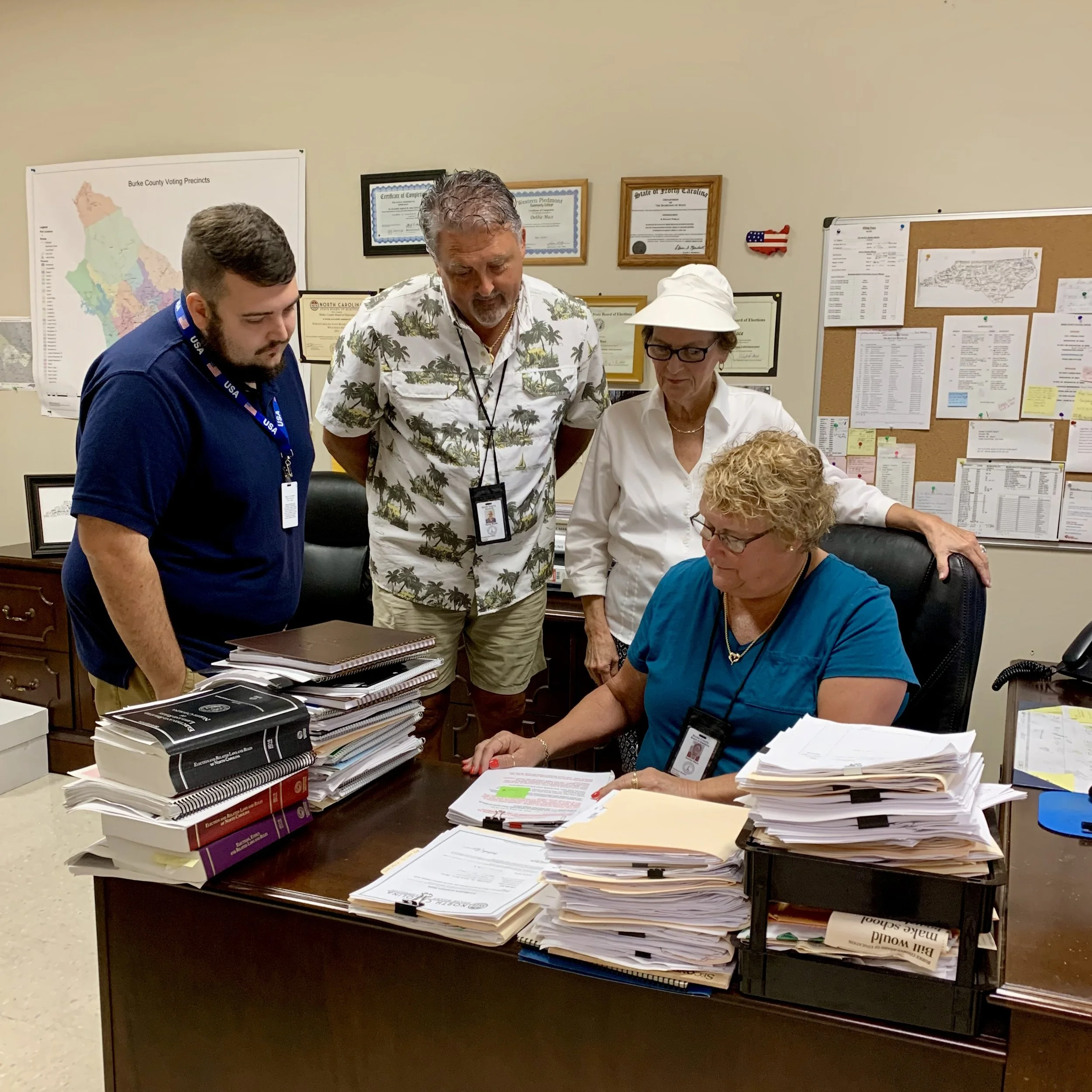 Burke Staff huddle around Director, Debbie Mace.