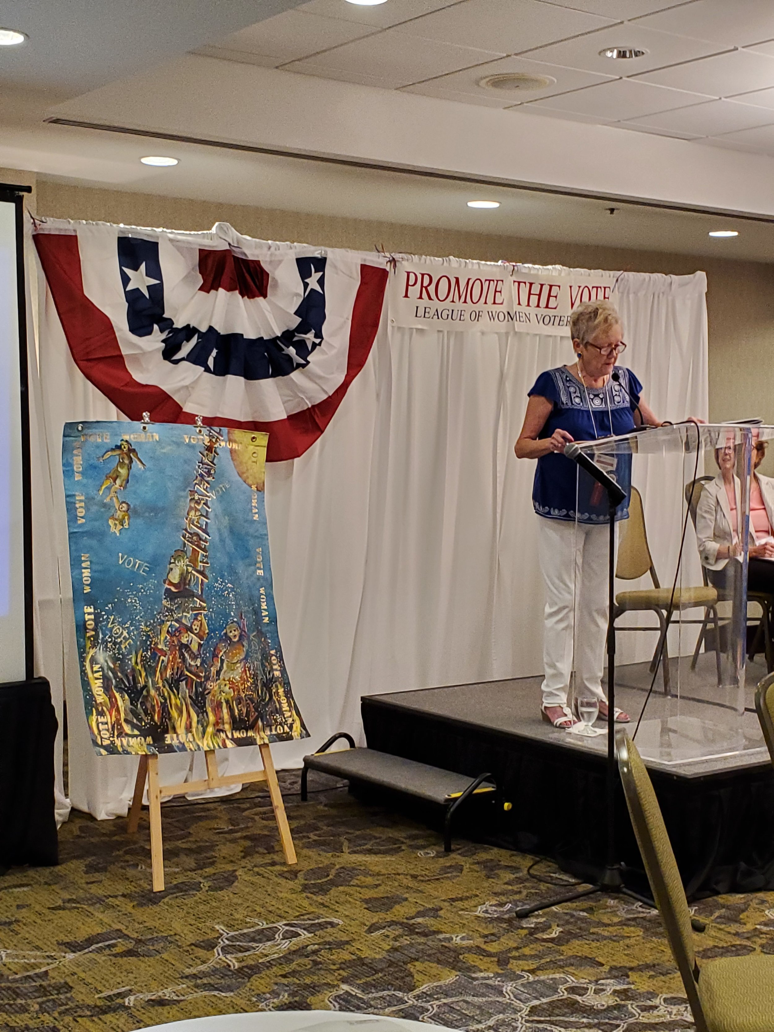 Outgoing LWVNC President Jo Nichols with Joanie Gardner_s donated artwork.jpg