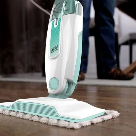 A steam mop cleaning a hardwood floor.