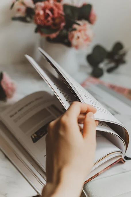 Woman's hand turning the page of a book