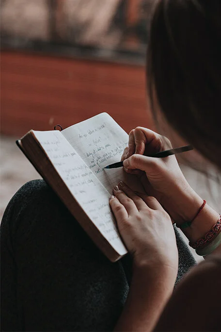 Woman writing in a notebook