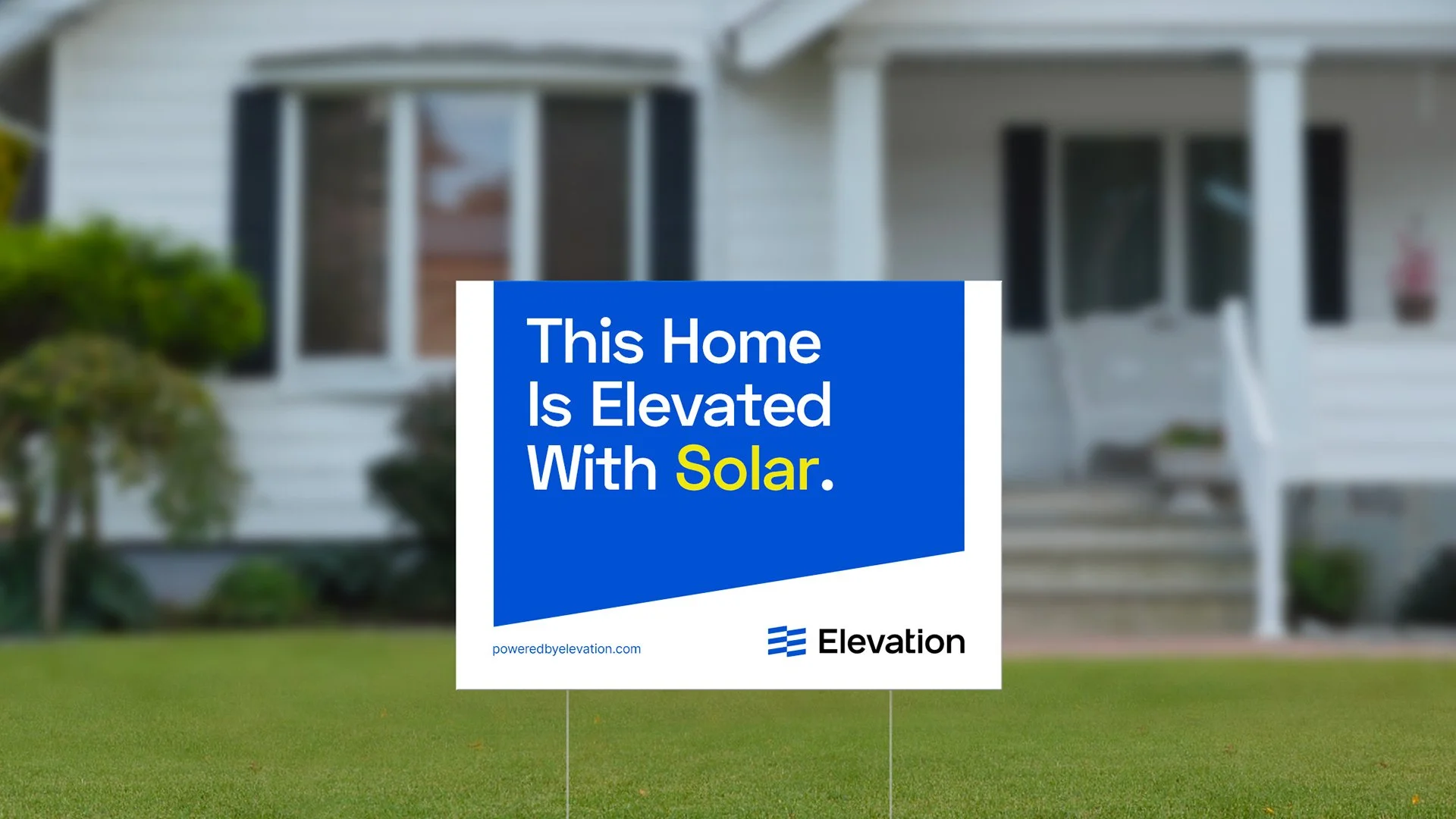 Solar power sign by home reading "This Home Is Elevated With Solar," with Elevation logo.